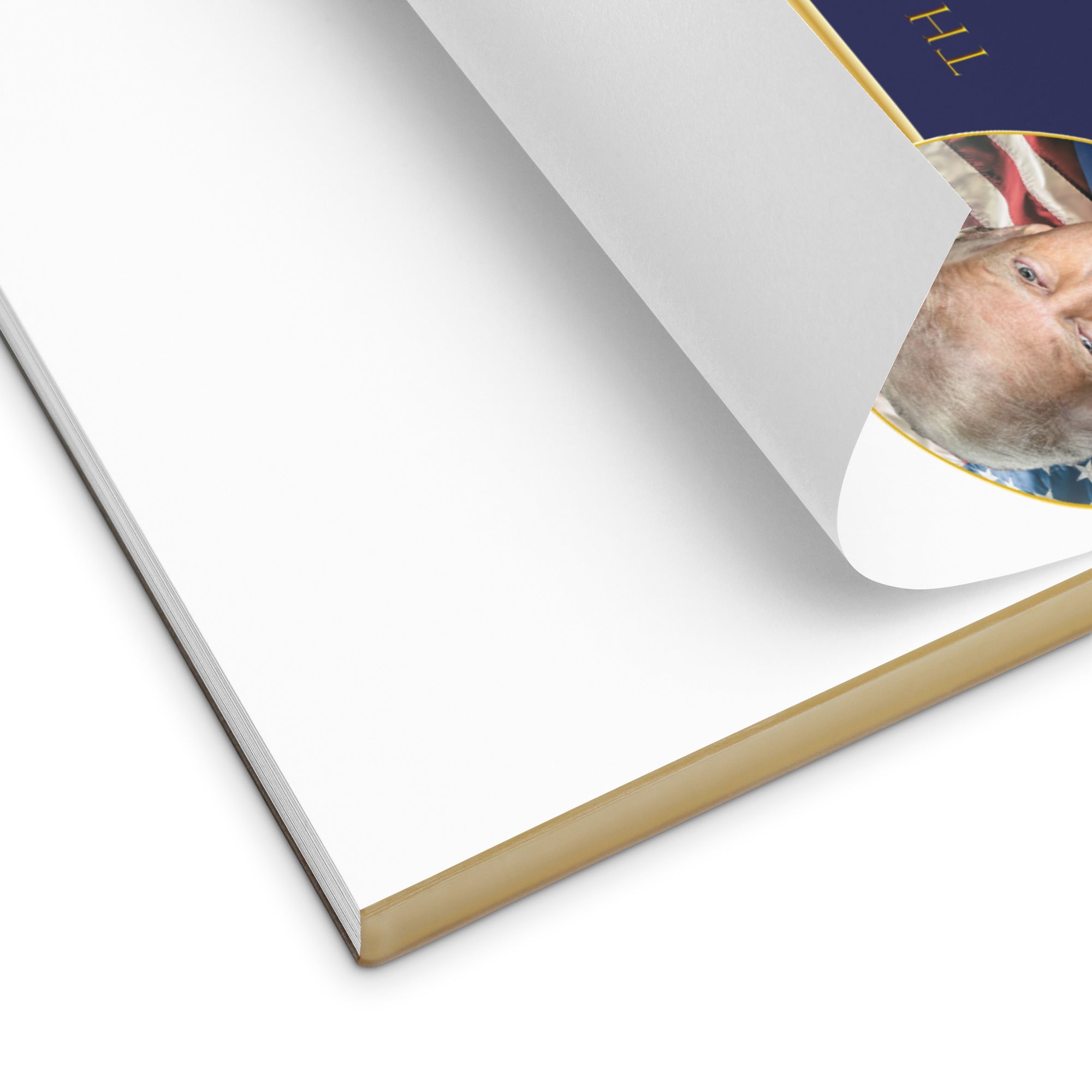 Close-up of a notebook with a portrait on the cover, showing a white page and gold edge. A close up of A notepad with a portrait of Donald Trump that says "Thank You for Your Attention to this Matter" by Liberty Maniacs