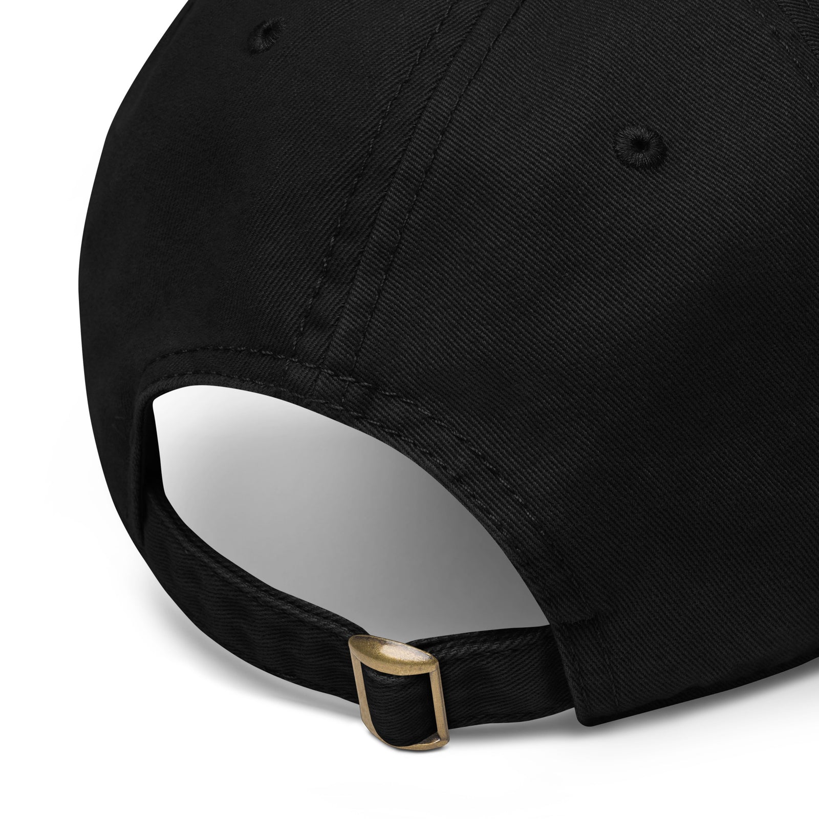 Close-up of a black cap with a gold buckle on a white background