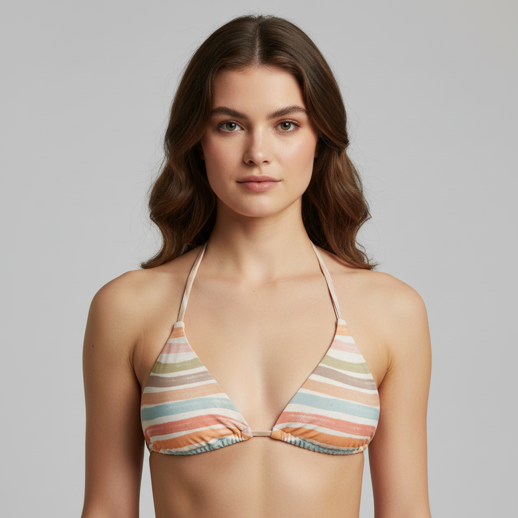 Woman wearing a colorful striped bikini top against a gray background