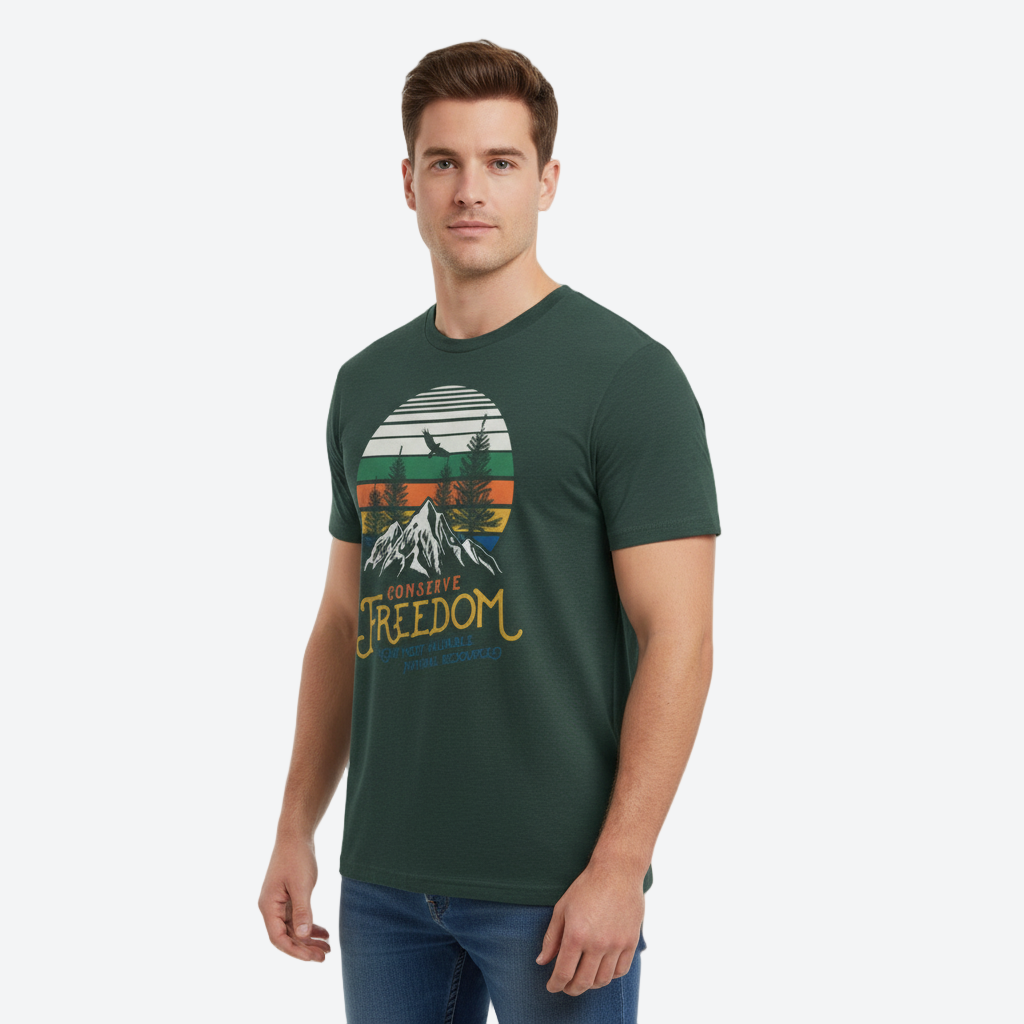 Man wearing a green t-shirt with a mountain graphic and &#39;Conserve Freedom&#39; text on a white background