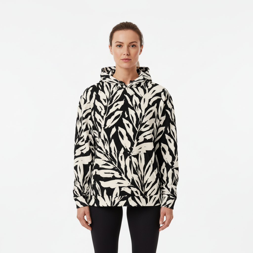 Person wearing a black and white patterned hoodie on a white background