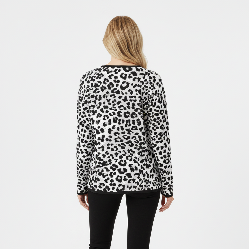 Woman wearing a snow leopard knit sweater on a white background