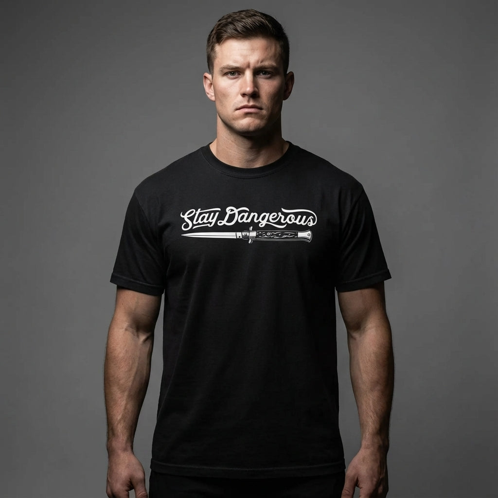 Man wearing a black t-shirt with 'Stay Dangerous' text and graphic on a gray background