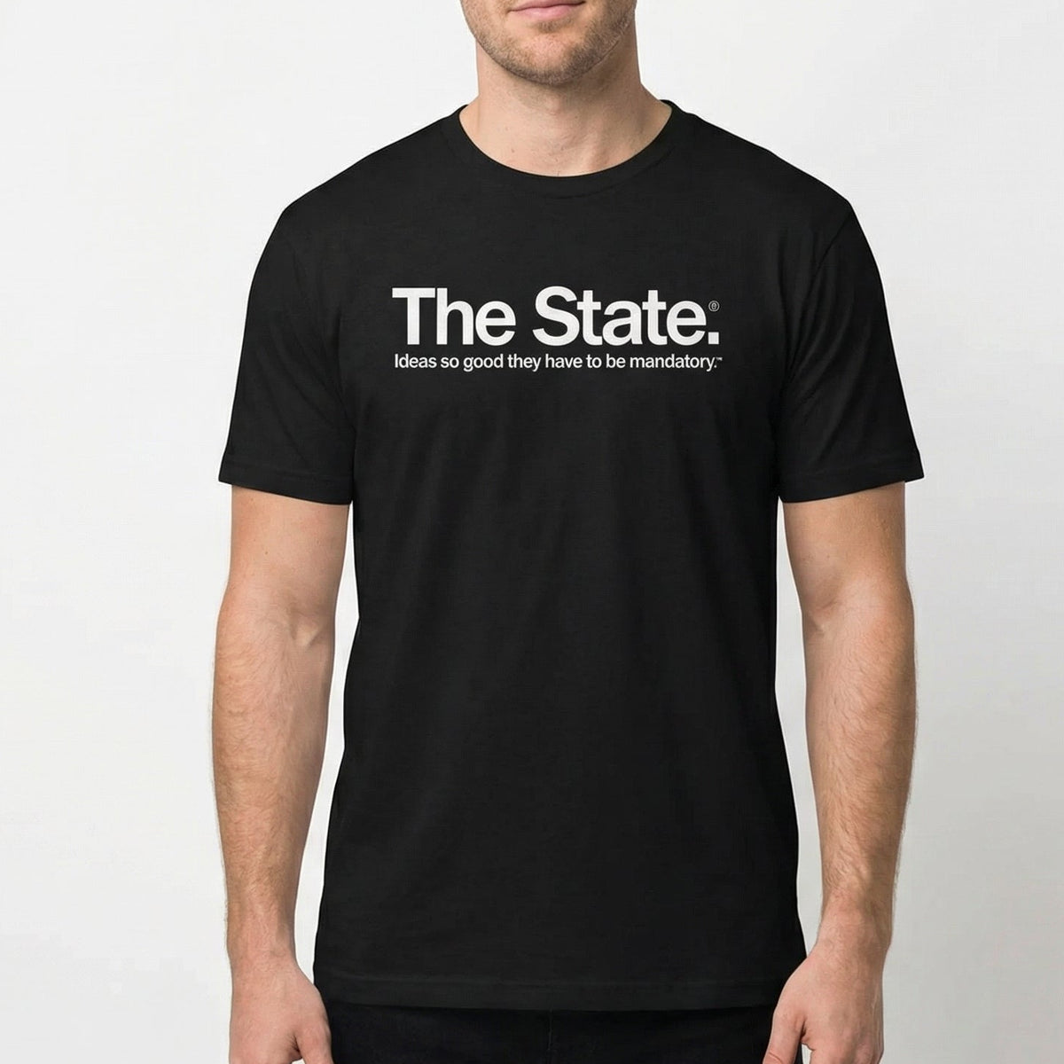 Man wearing a black t-shirt with &#39;The State. Ideas so good they have to be mandatory&#39; text on a white background