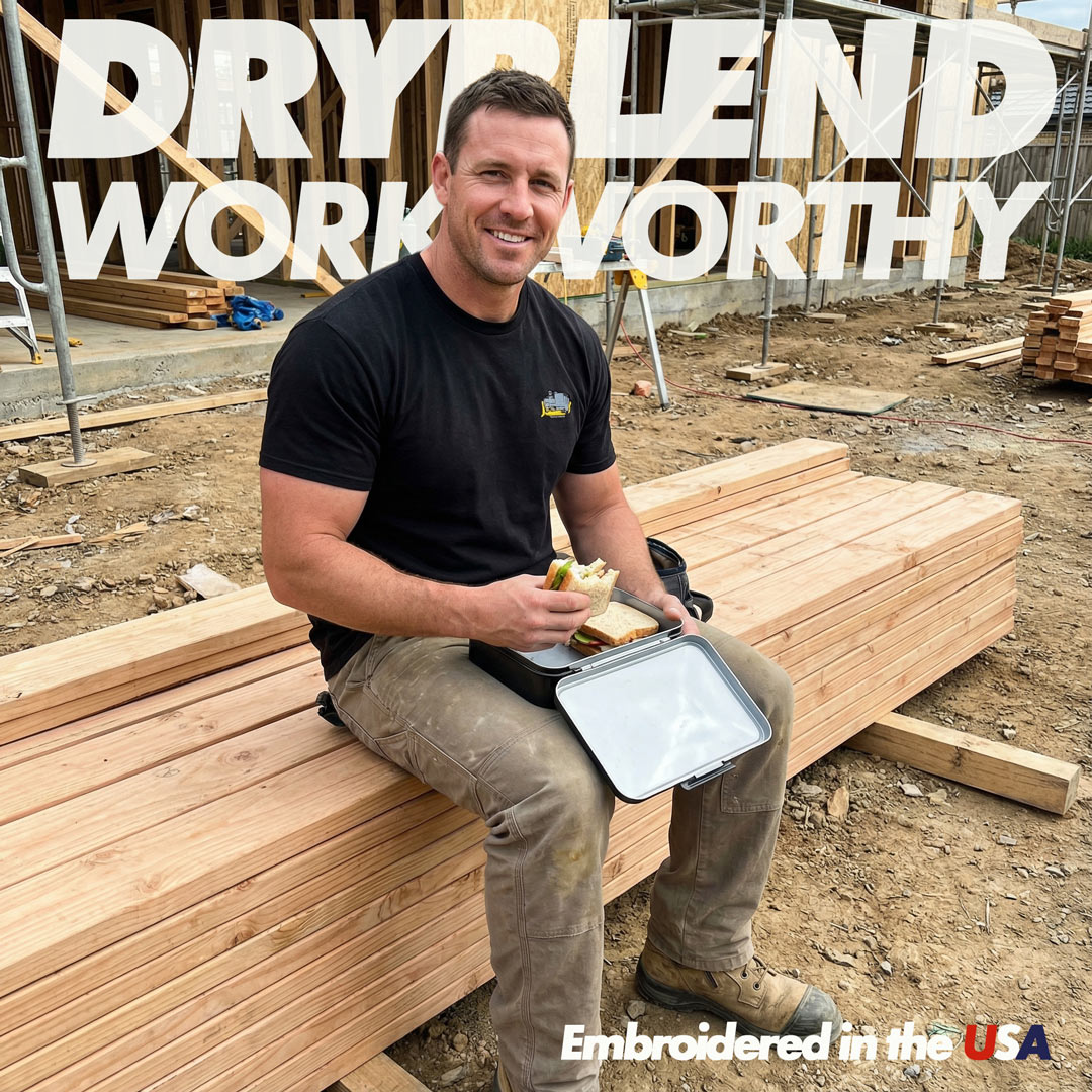 Man sitting on wooden planks at a construction site with 'Dryblend Work Worthy' text in the background.
