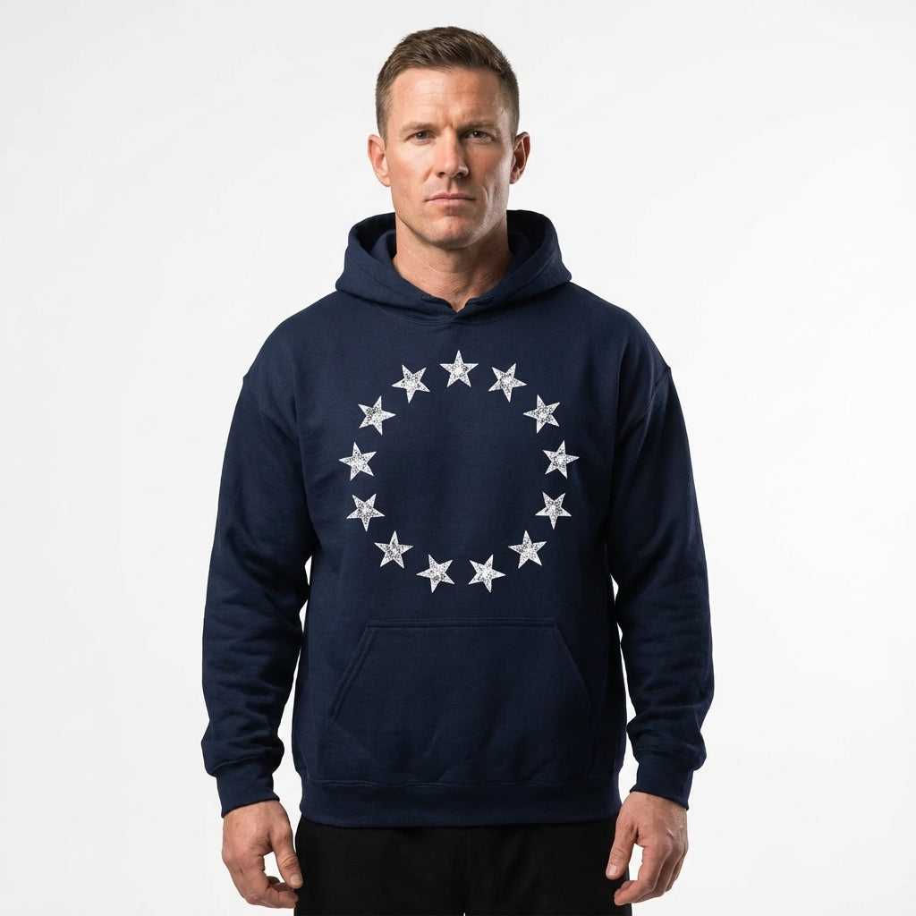 Man wearing a navy blue hoodie with star design on a white background