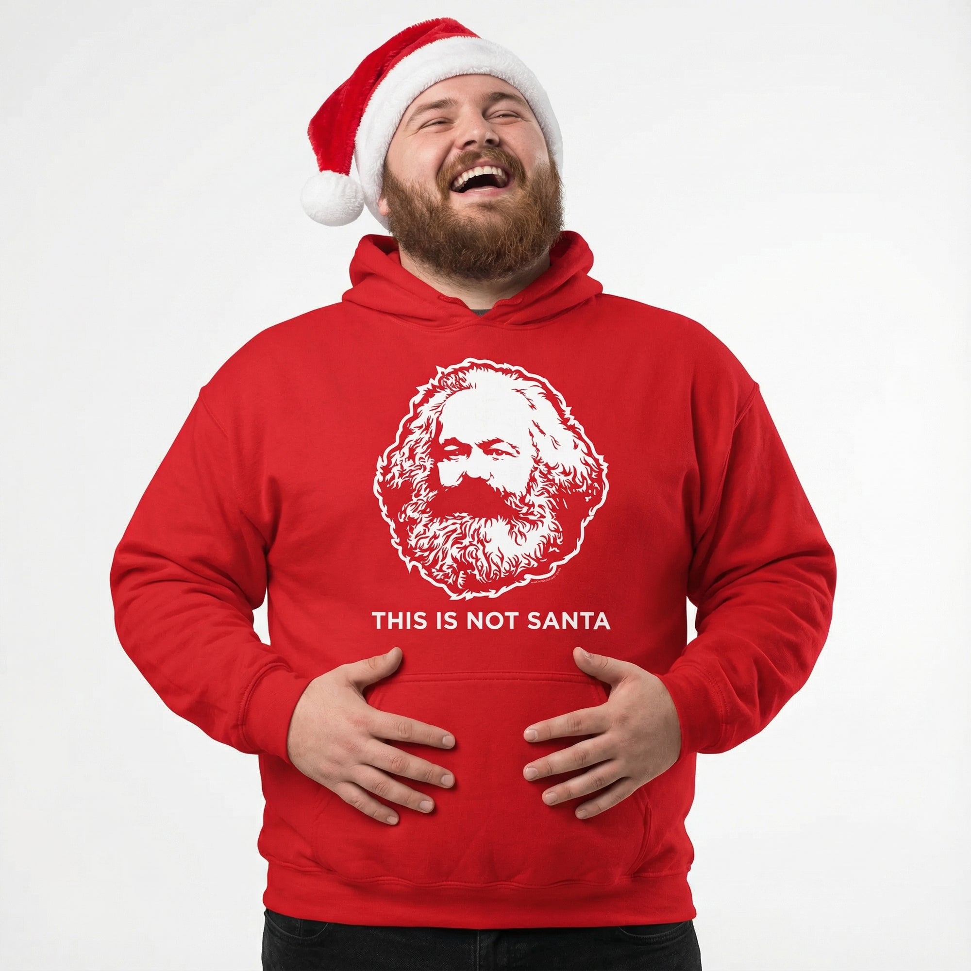 Man wearing a red hoodie with a printed face and 'This is Not Santa' text, laughing.