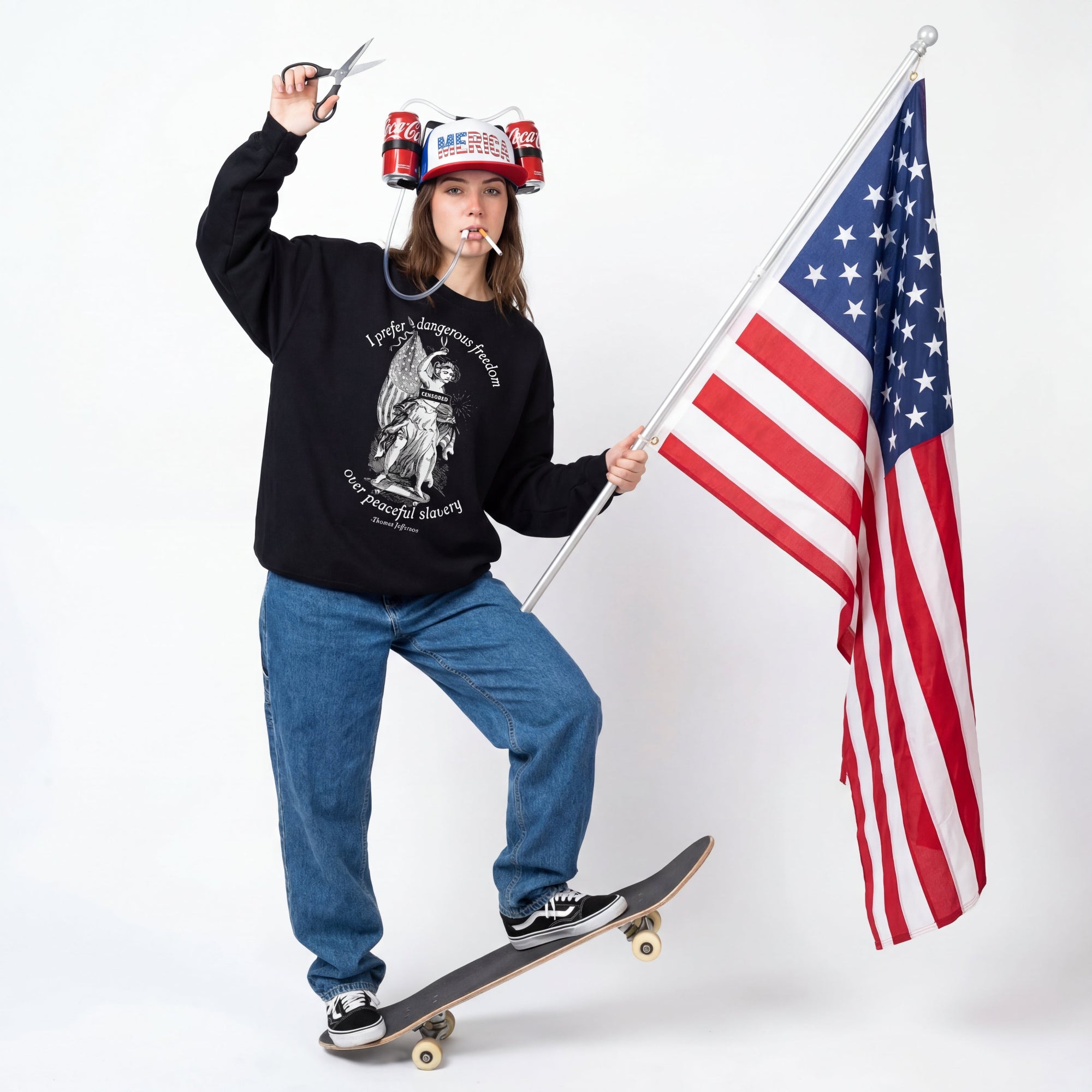Person holding an American flag and a pair of scissors, wearing a black sweatshirt and blue jeans, on a white background.