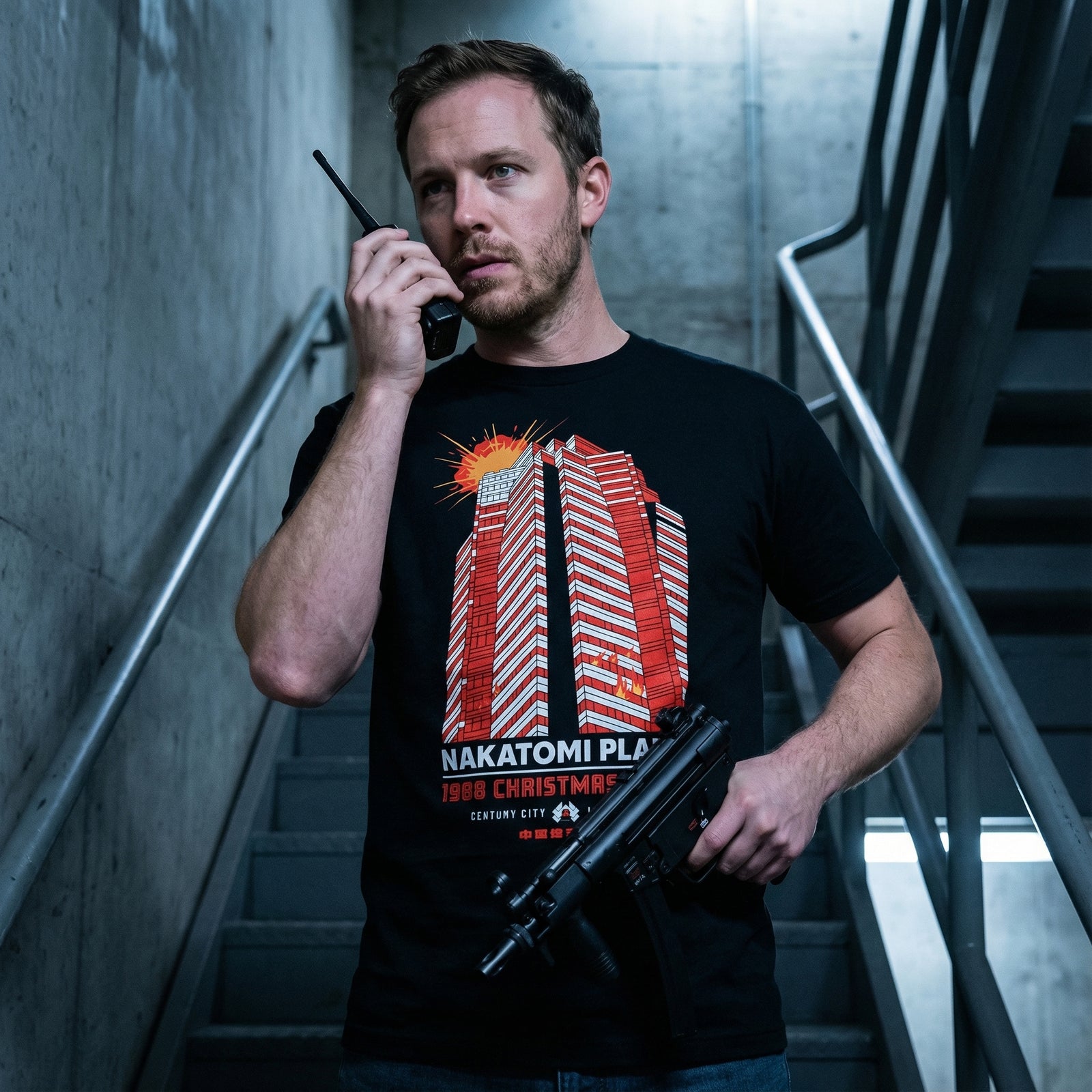 Black t-shirt with red and white building graphic and text on a white background