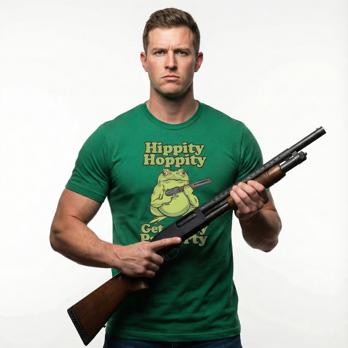 Man wearing a green Hippity Hoppity Get Off My Property Unisex T-Shirt with a frog graphic, holding a shotgun on a white background