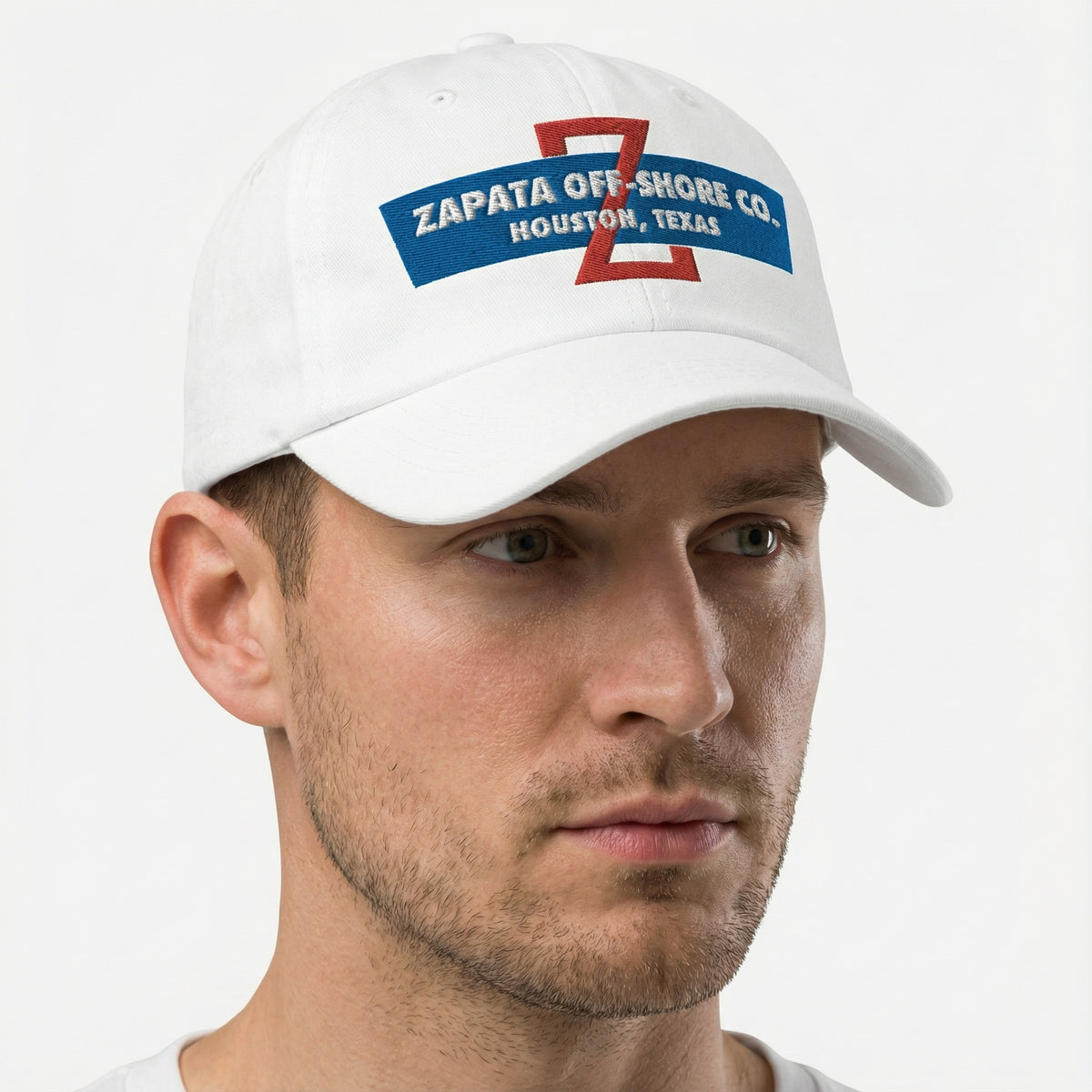 Man wearing a white cap with Zapata Off-Shore Co logo on a white background
