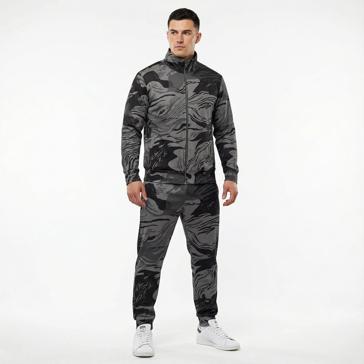 Man wearing a camouflage tracksuit on a white background