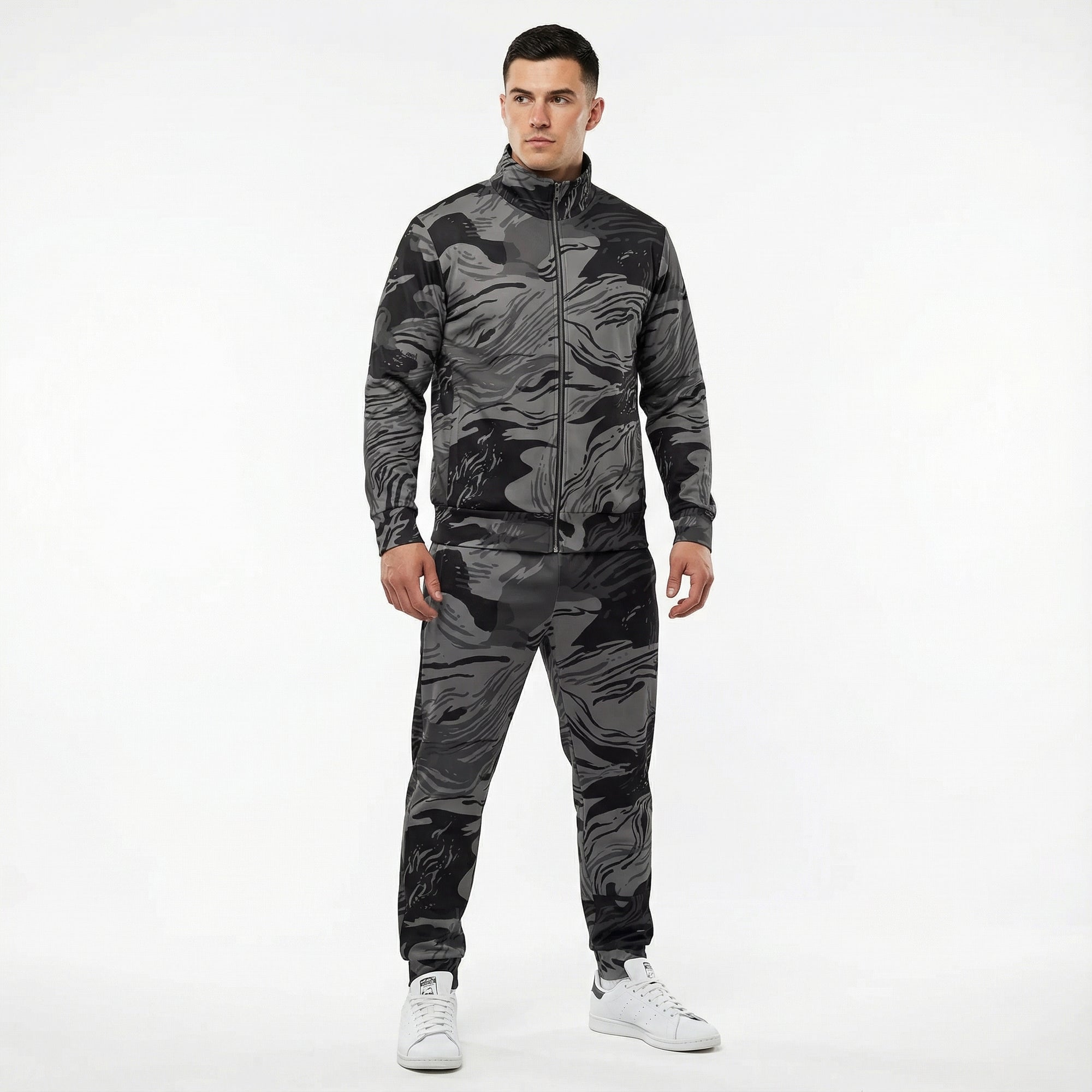 Man wearing a camouflage tracksuit on a white background