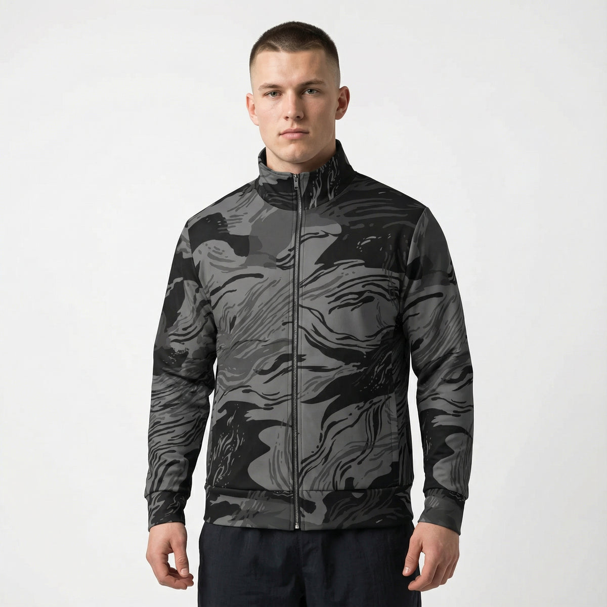 Man wearing a black and gray camouflage jacket on a white background