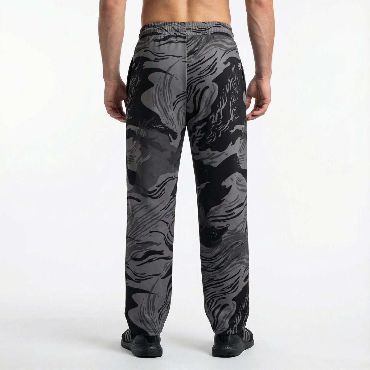 Black and gray patterned pants worn by a person on a white background
