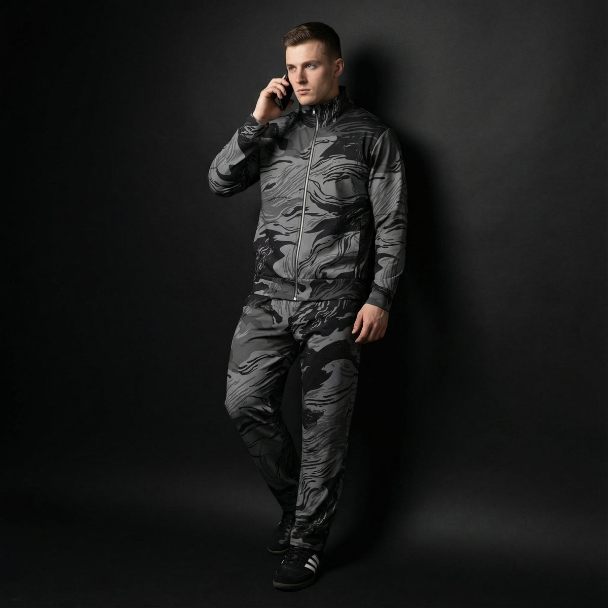 Man wearing a camouflage jumpsuit against a black background