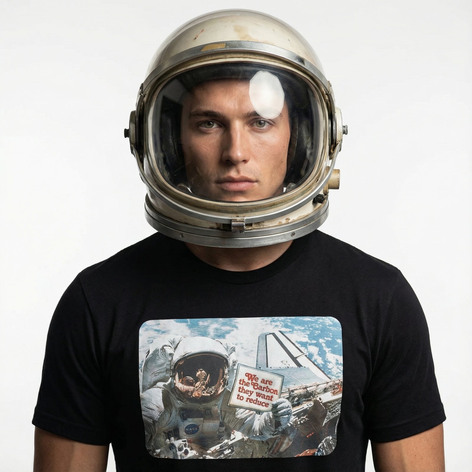 Person wearing an astronaut helmet and a black t-shirt with space-themed design