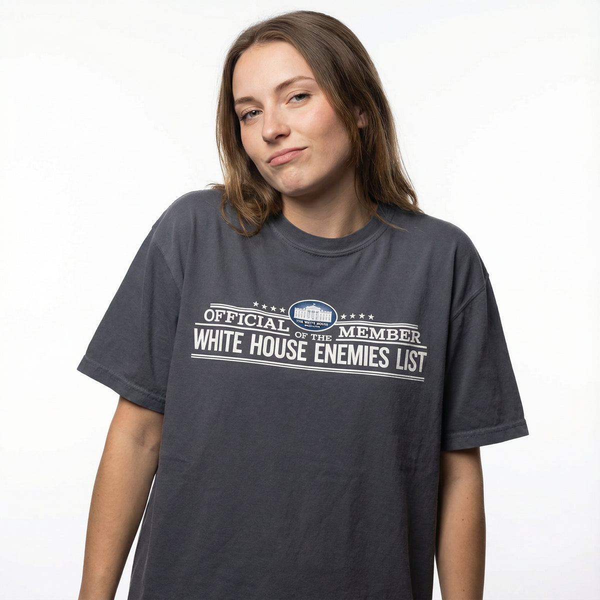 Person wearing a t-shirt with 'Official Member White House Enemies List' text on a white background