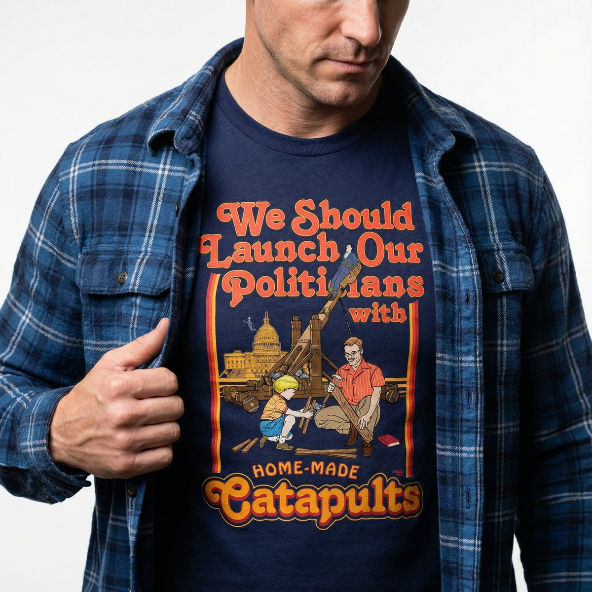 Person wearing a t-shirt with a humorous graphic and text about launching politicians with catapults.