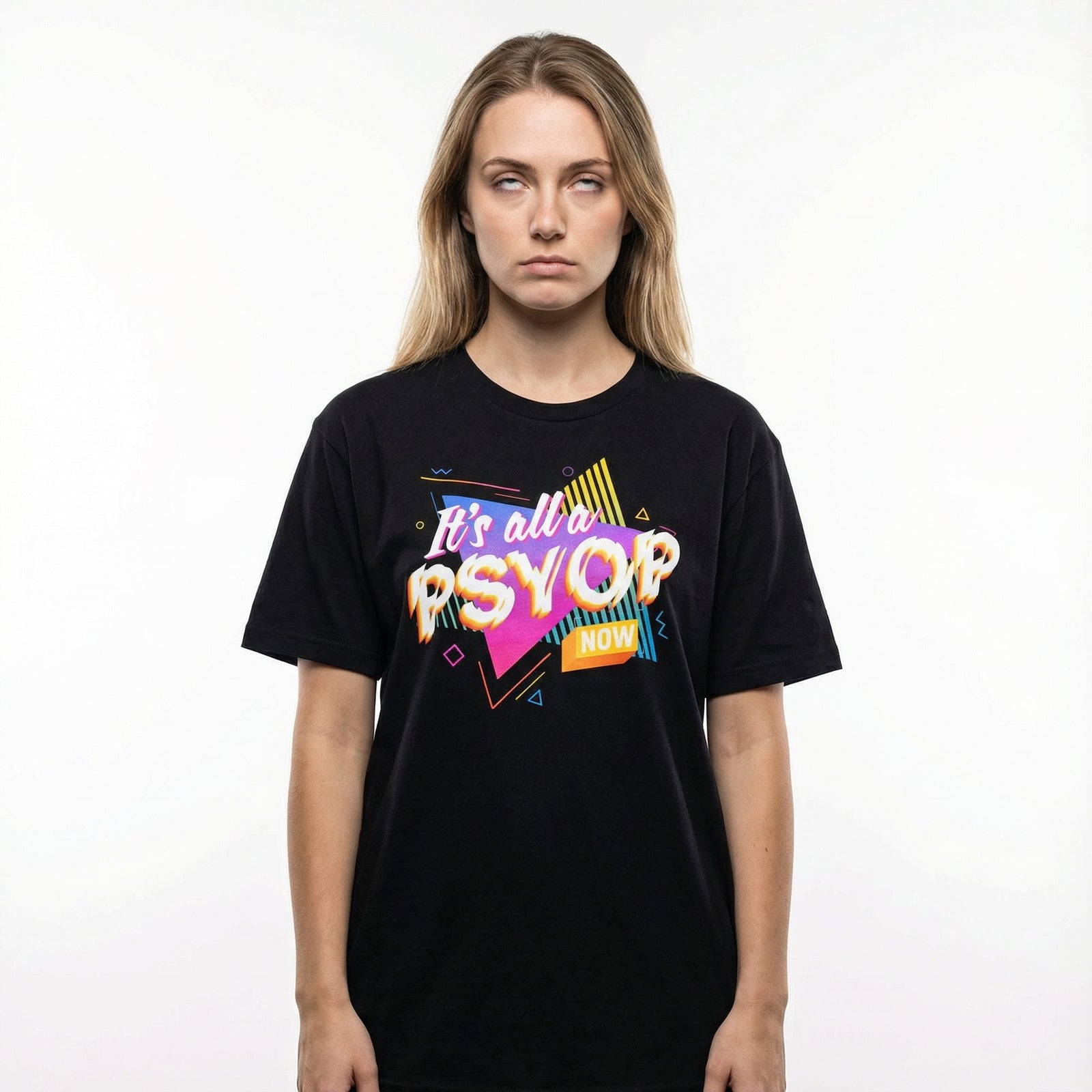 Woman rolling her eyes wearing a black t-shirt with colorful retro text saying "It's all a Psyop Now" on a white background