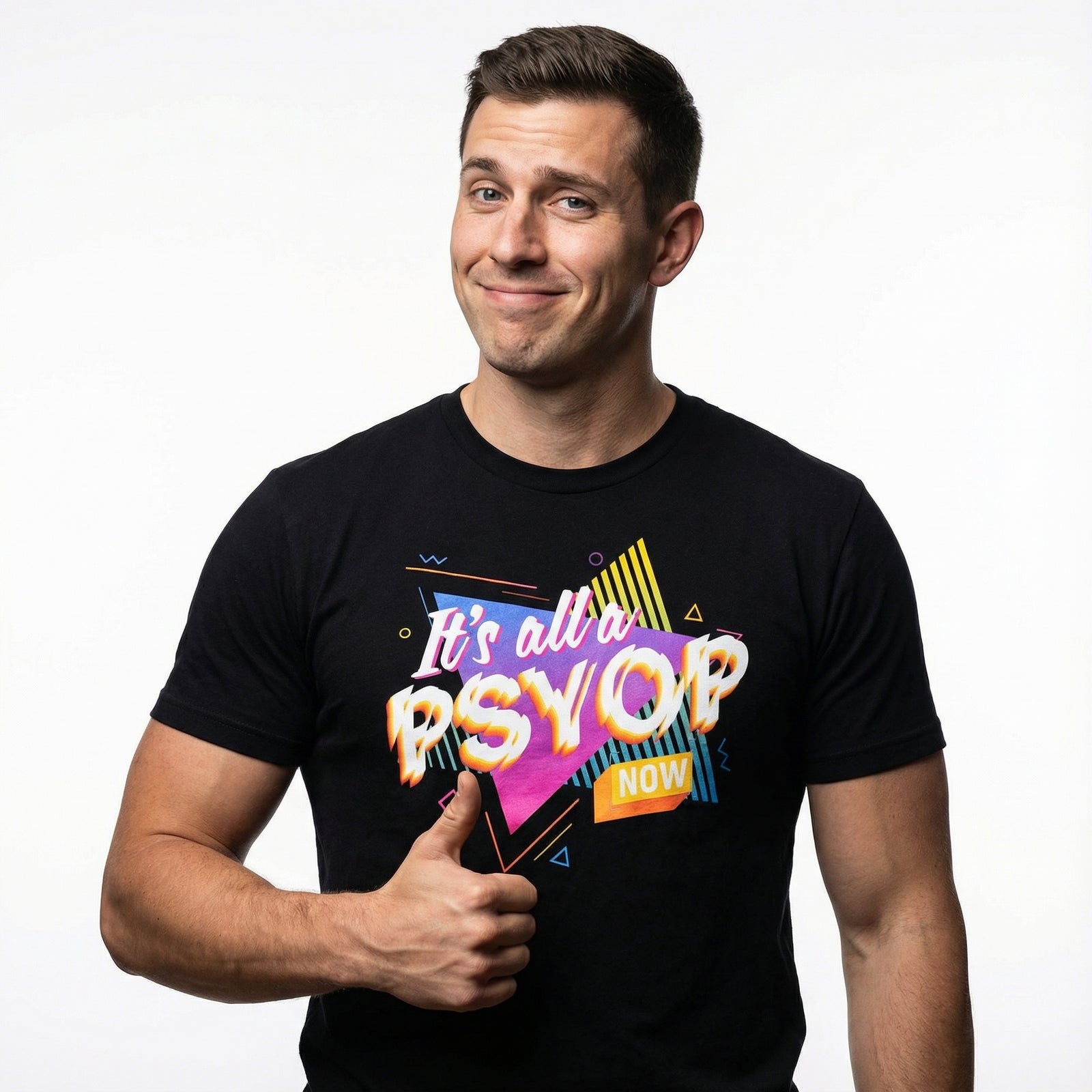 Man wearing a black t-shirt with colorful retro text saying "It's all a Psyop Now" on a white background