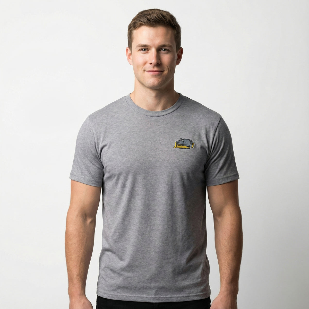 Man wearing a gray t-shirt with a small embroidered Killdozer logo on a white background