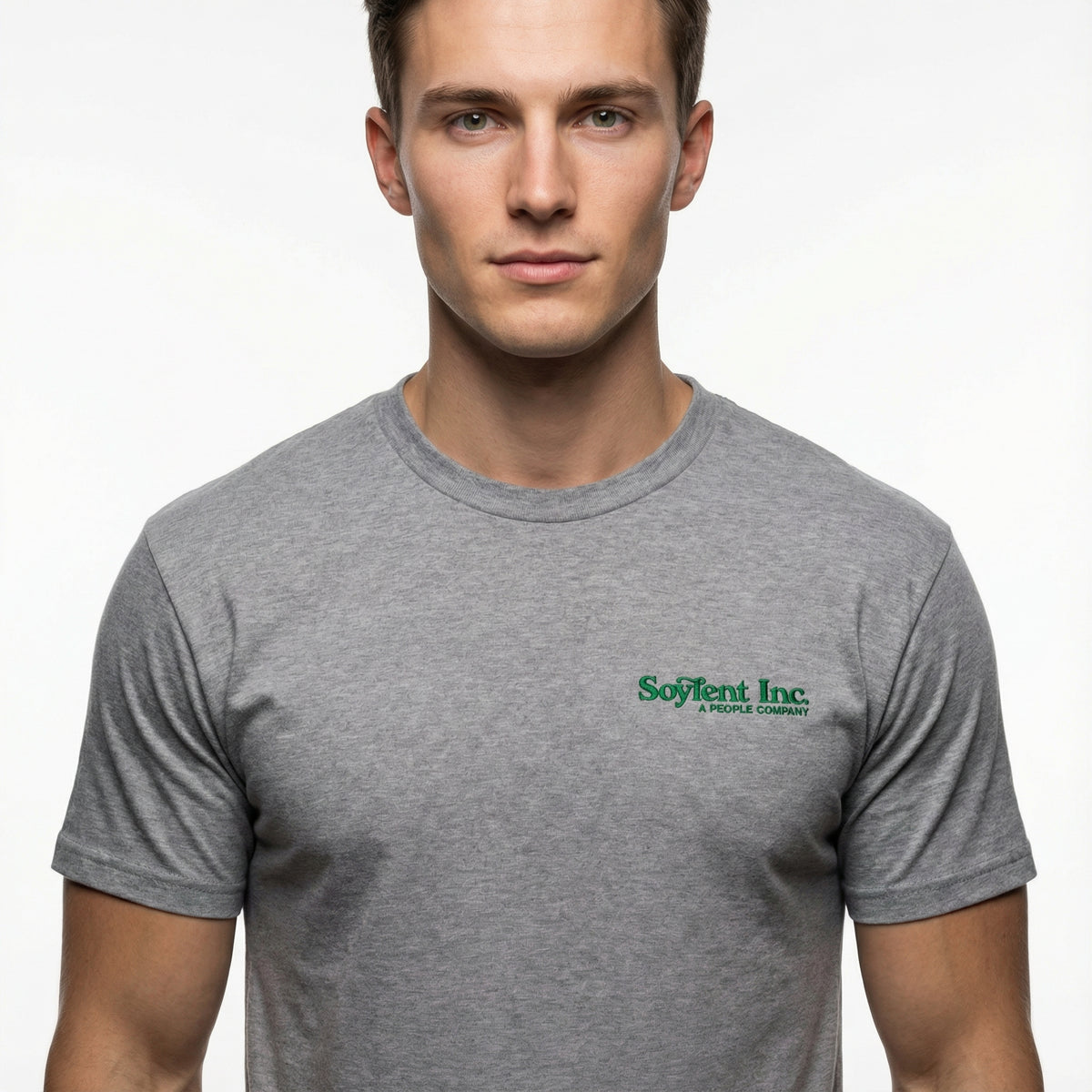 Man wearing a gray t-shirt with a logo on a plain background