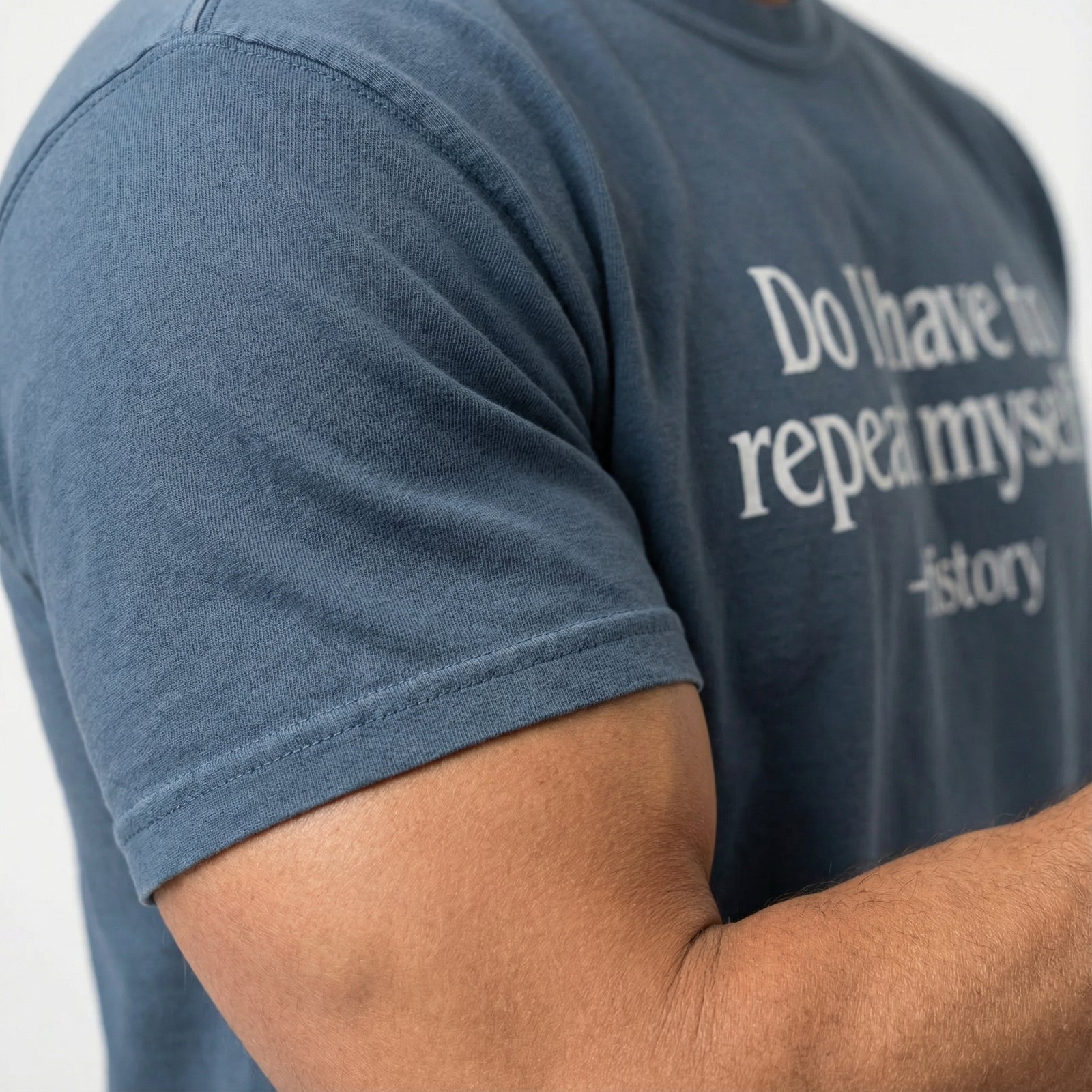 Person wearing a blue t-shirt with text on a white background
