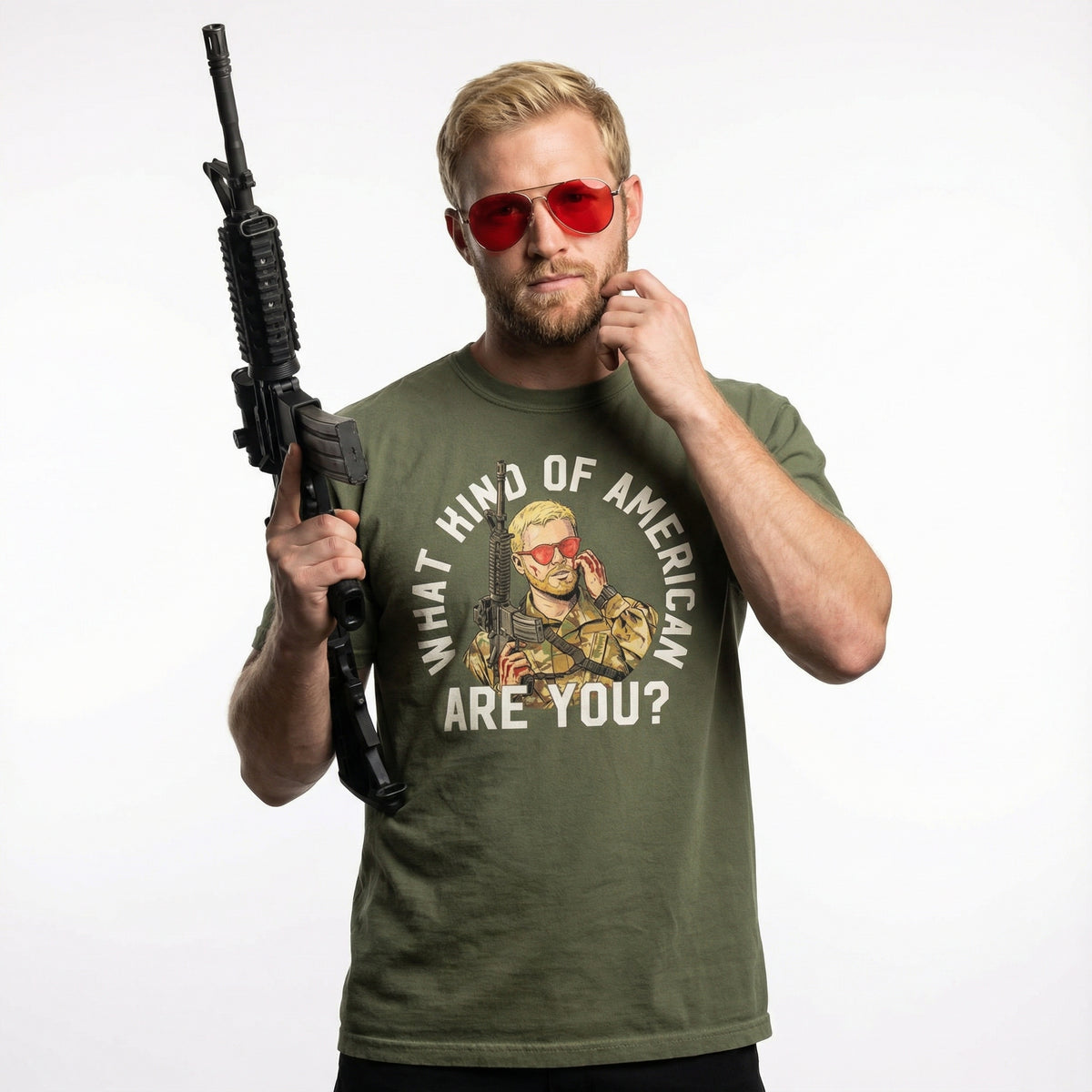 Man wearing a green t-shirt with a graphic and text, holding a rifle on a white background