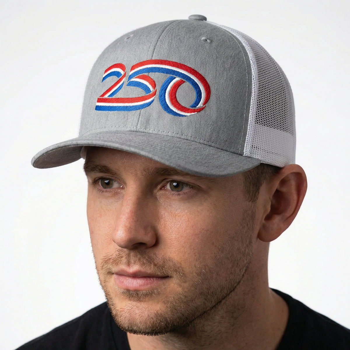 Man wearing a gray cap with a colorful 250th American Anniversary logo on a white background