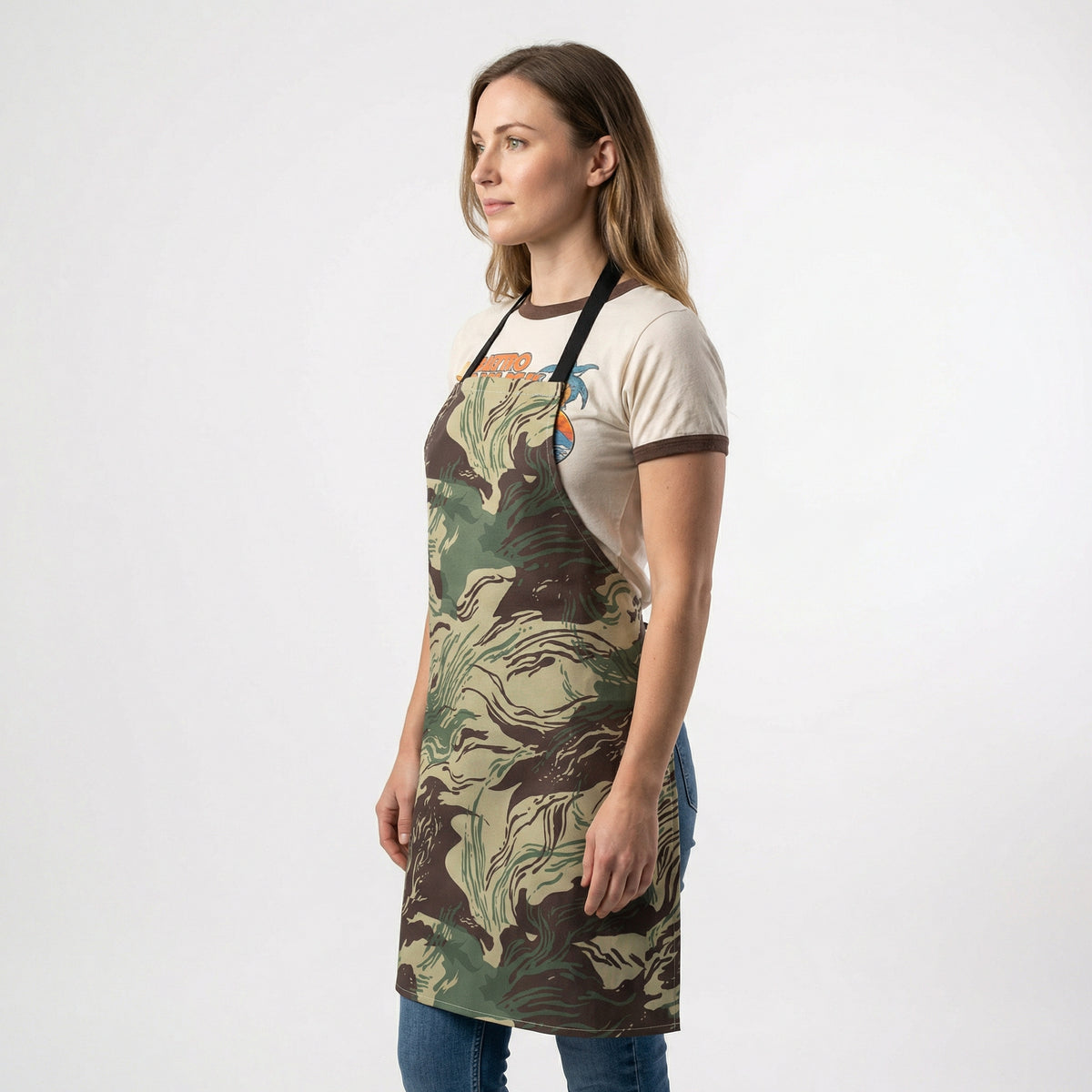 Woman wearing a camouflage apron on a white background