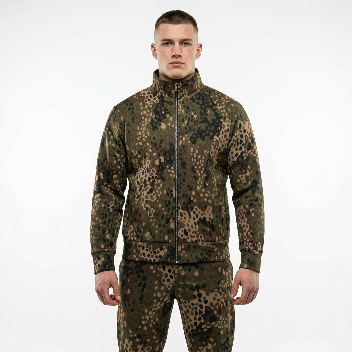 Man wearing a camouflage jacket and pants on a white background