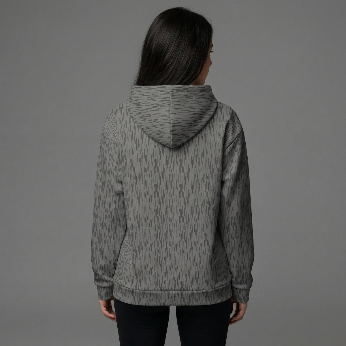 Person wearing a gray hoodie from behind on a gray background
