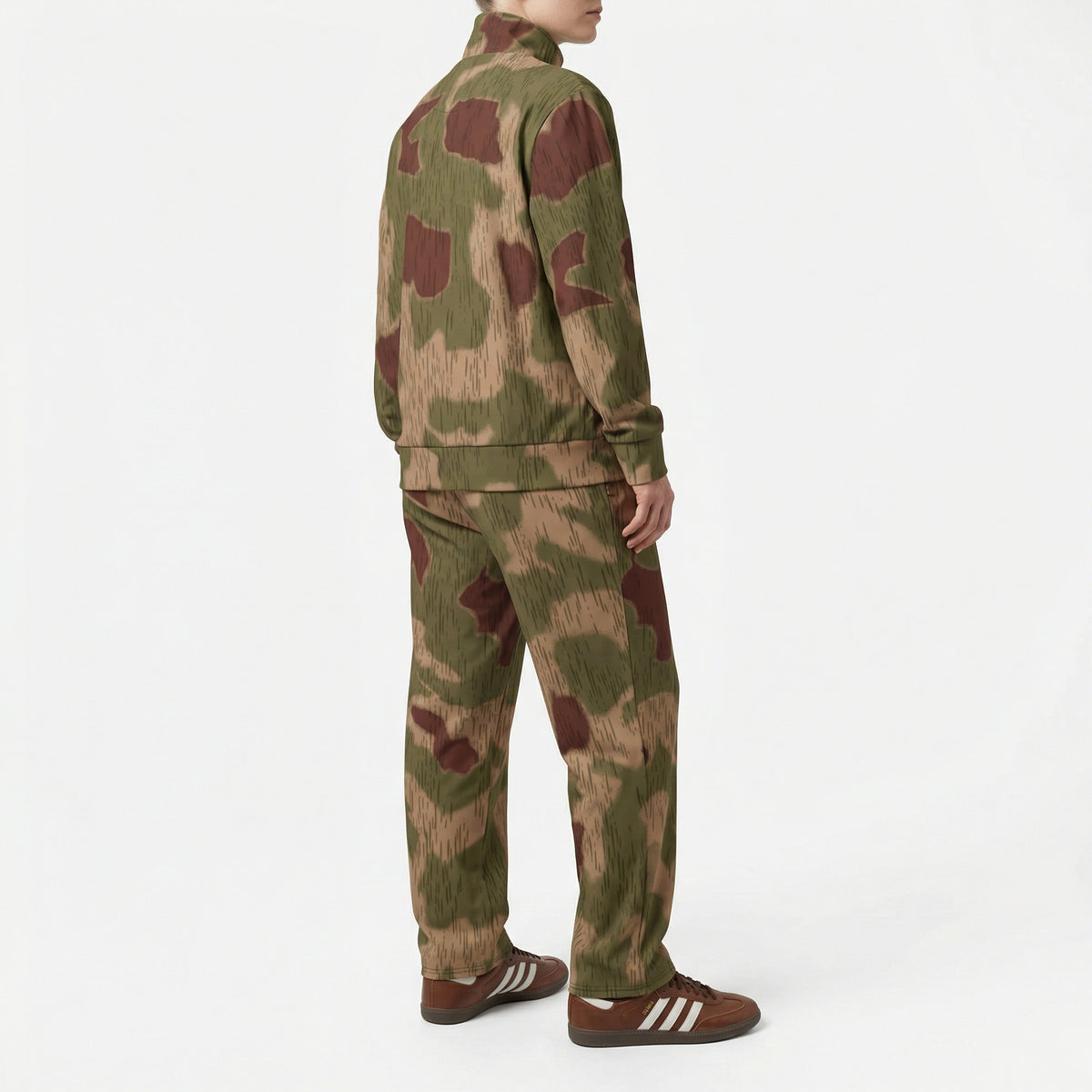 Person wearing a Sumpftarnmuster camouflage tracksuit with Adidas shoes on a white background