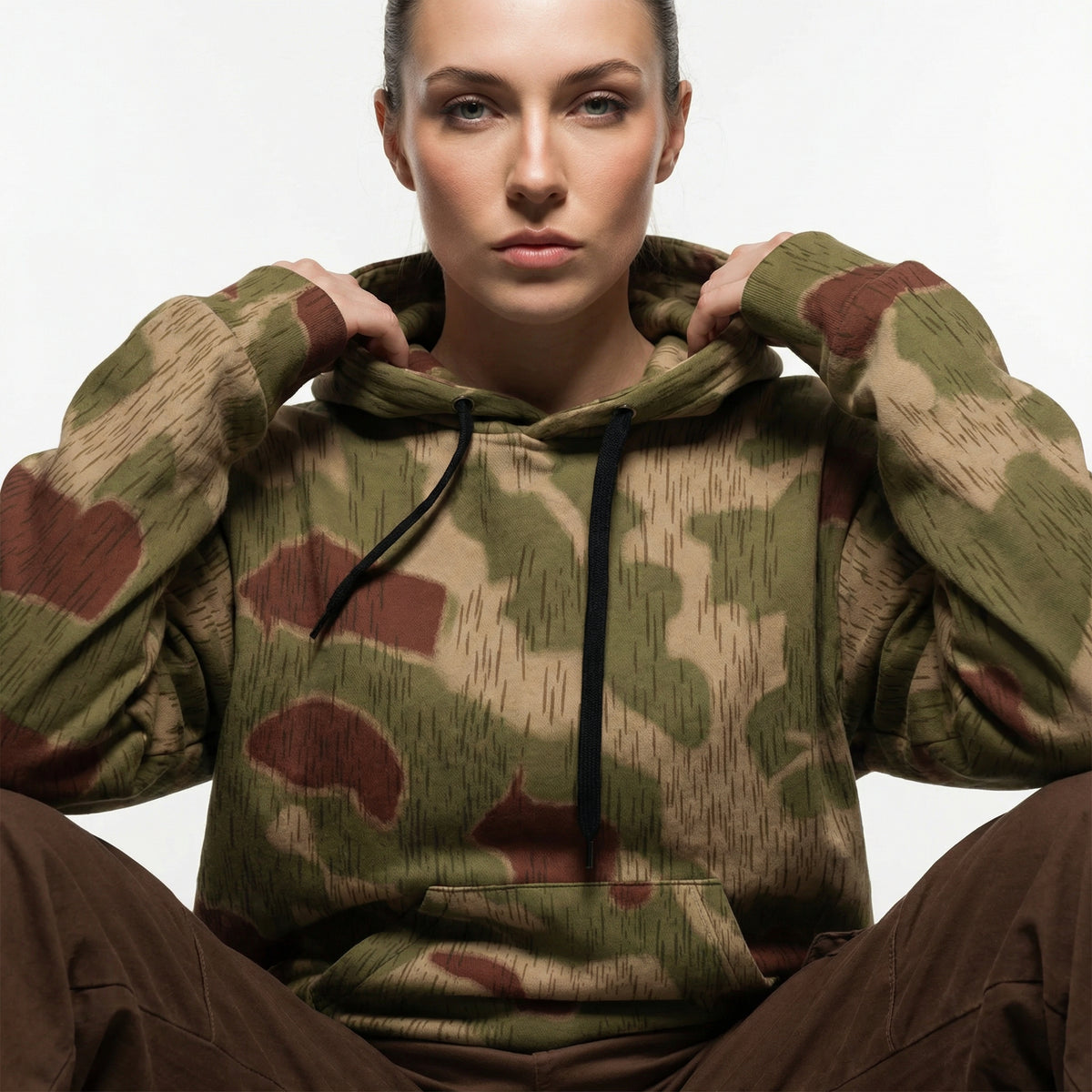 Person wearing a Sumpftarnmuster Camouflage Cotton Hoodie against a neutral background