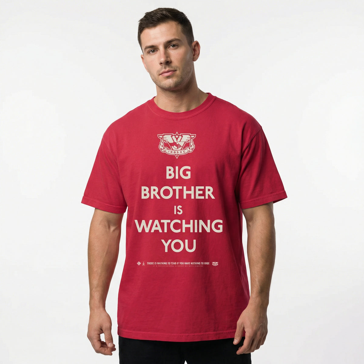 Man wearing a red t-shirt with 'Big Brother is Watching You' text on a white background