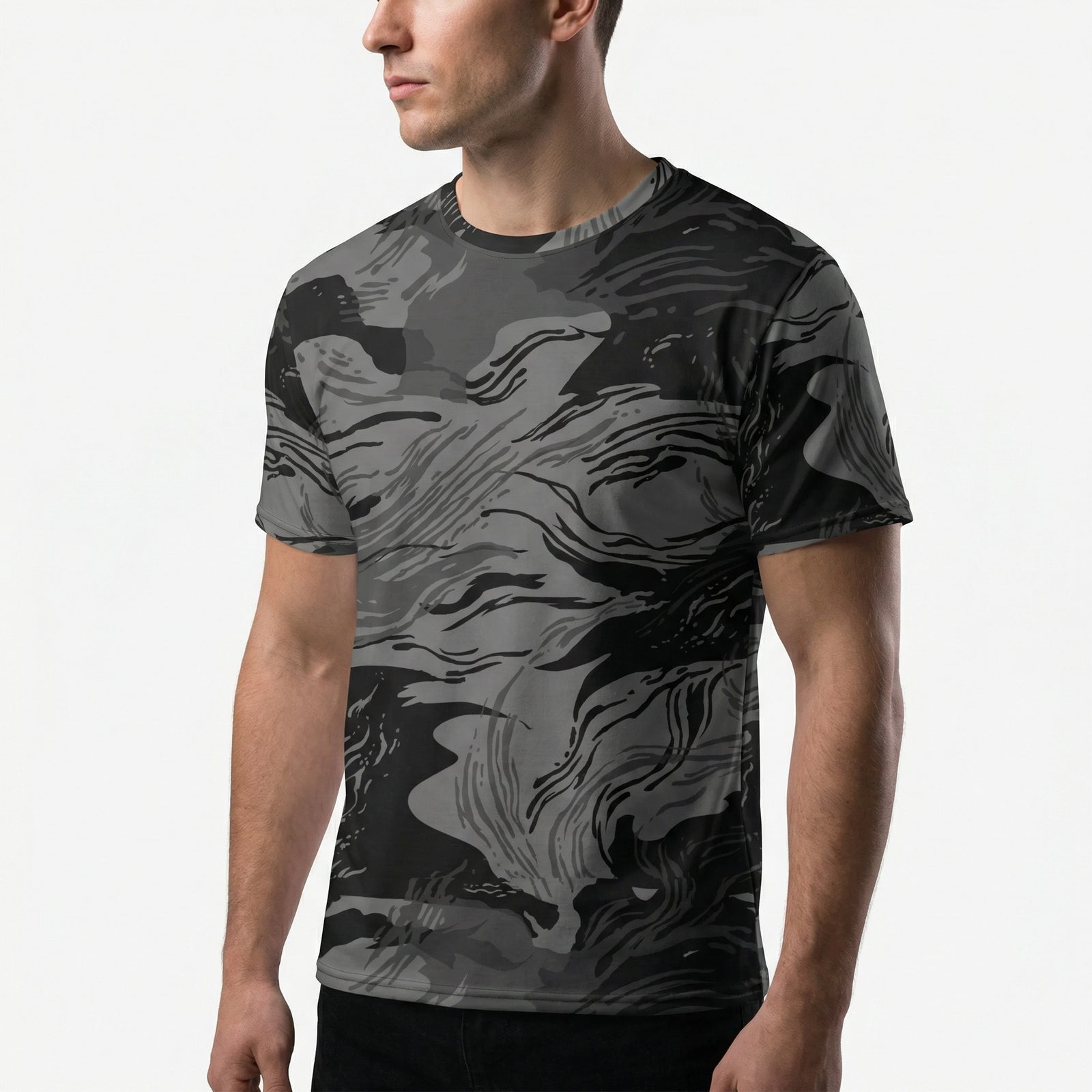 Person wearing a black and gray camouflage t-shirt on a white background