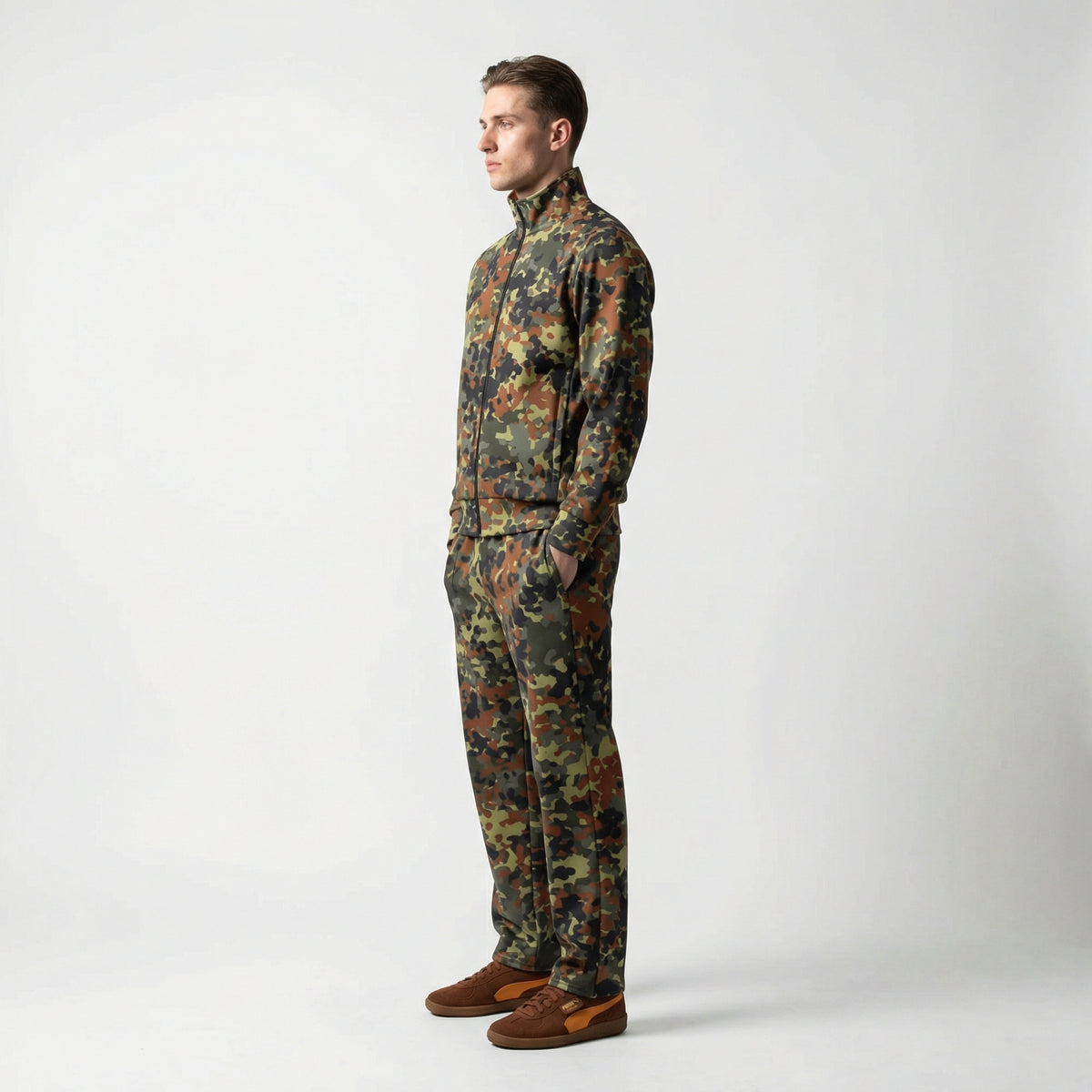 Man wearing a Flecktarn Recon camouflage outfit on a white background