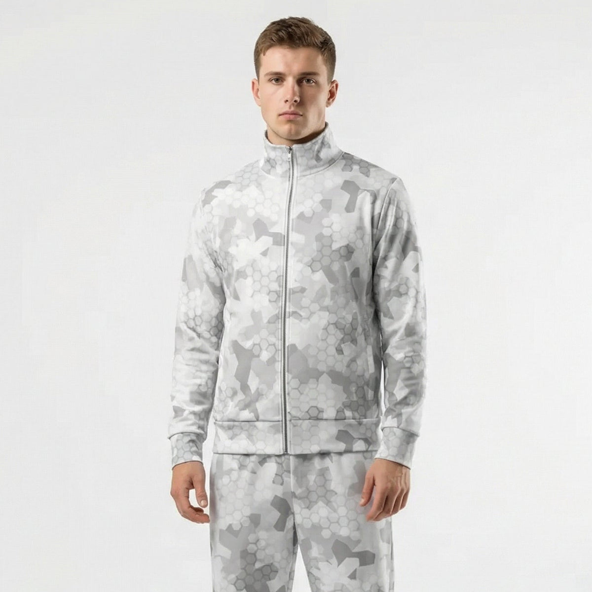 Man wearing a gray camouflage tracksuit on a white background