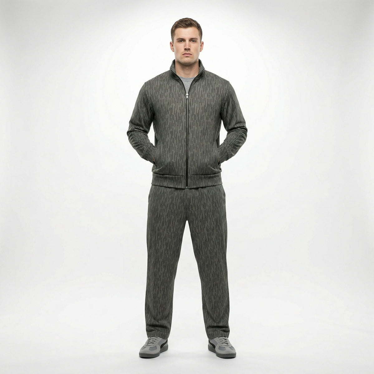 Man wearing a gray tracksuit on a white background. The tracksuit is by Liberty Maniacs and called the Strichtarn Raindrop Camo Track Jacket