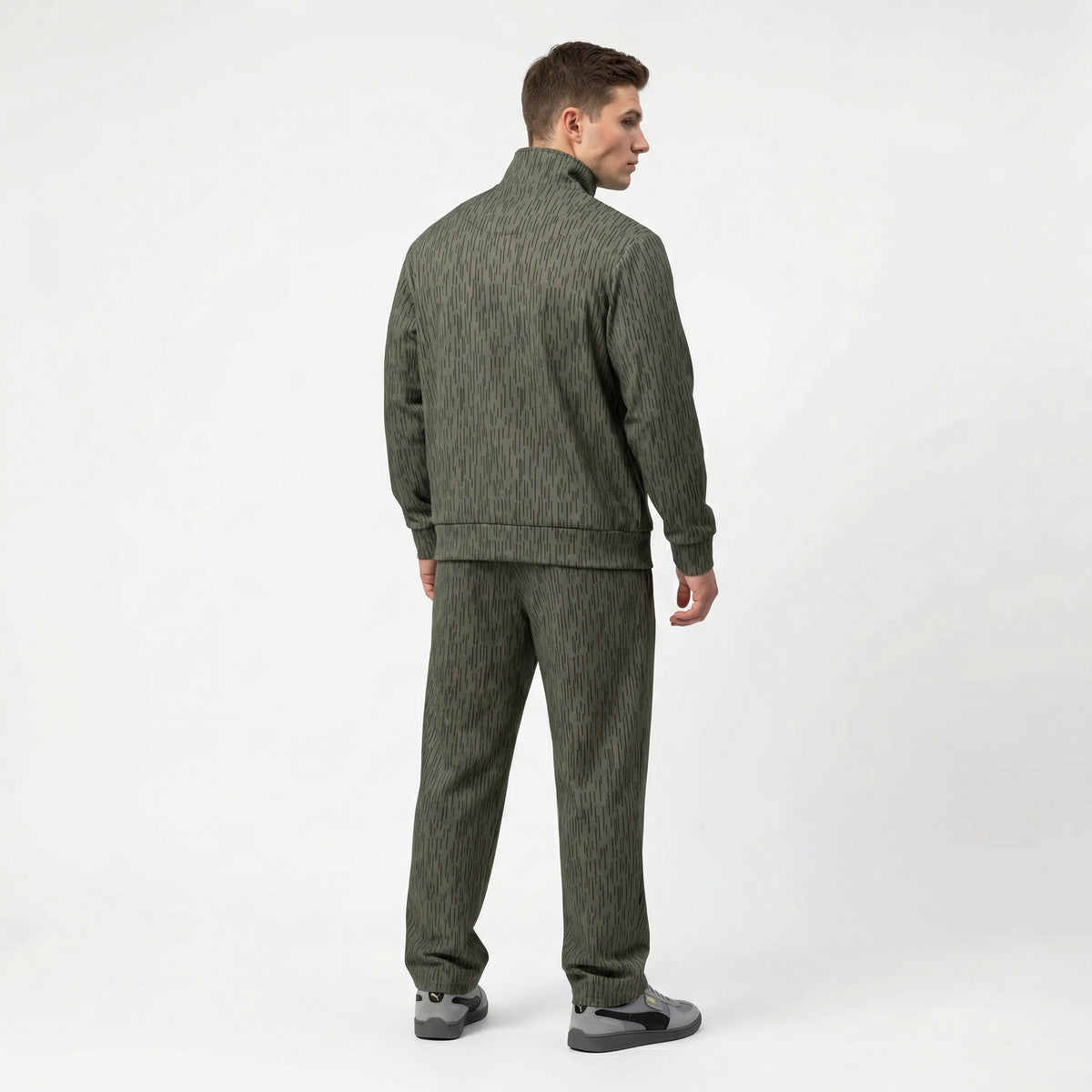 Man wearing a Strichtarn Raindrop Camo Track suit with wide leg jogger bottoms on a white background