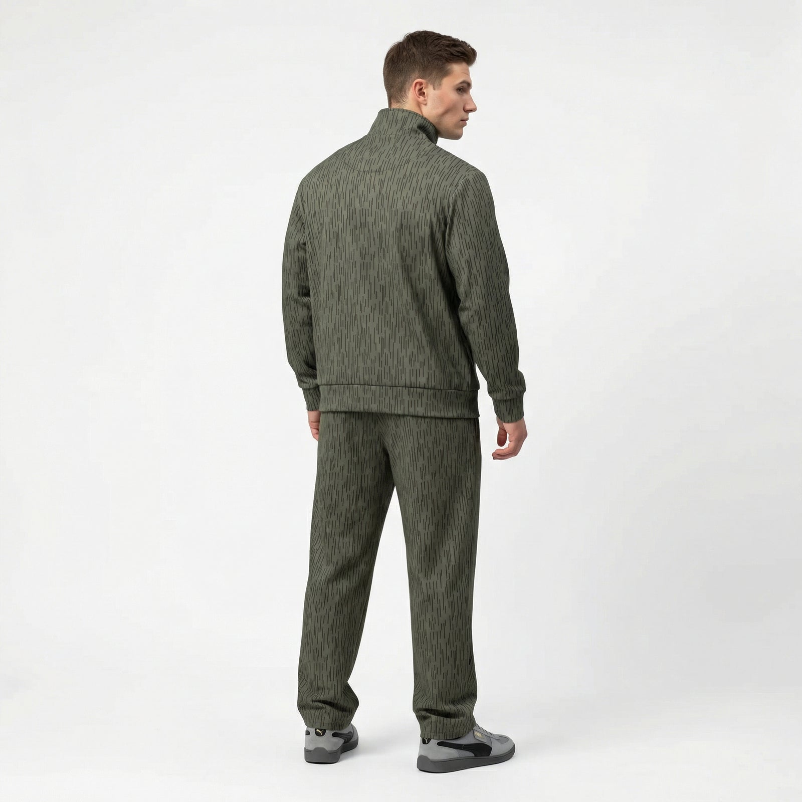 Man wearing a Strichtarn Raindrop Camo Track suit with wide leg jogger bottoms on a white background