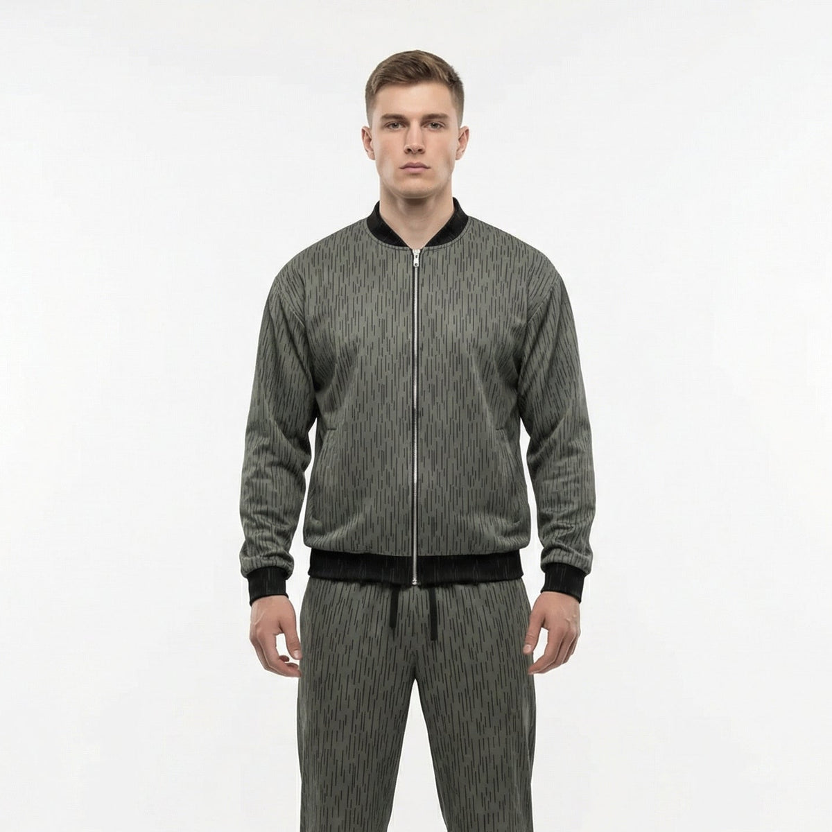 Man wearing a gray tracksuit on a white background