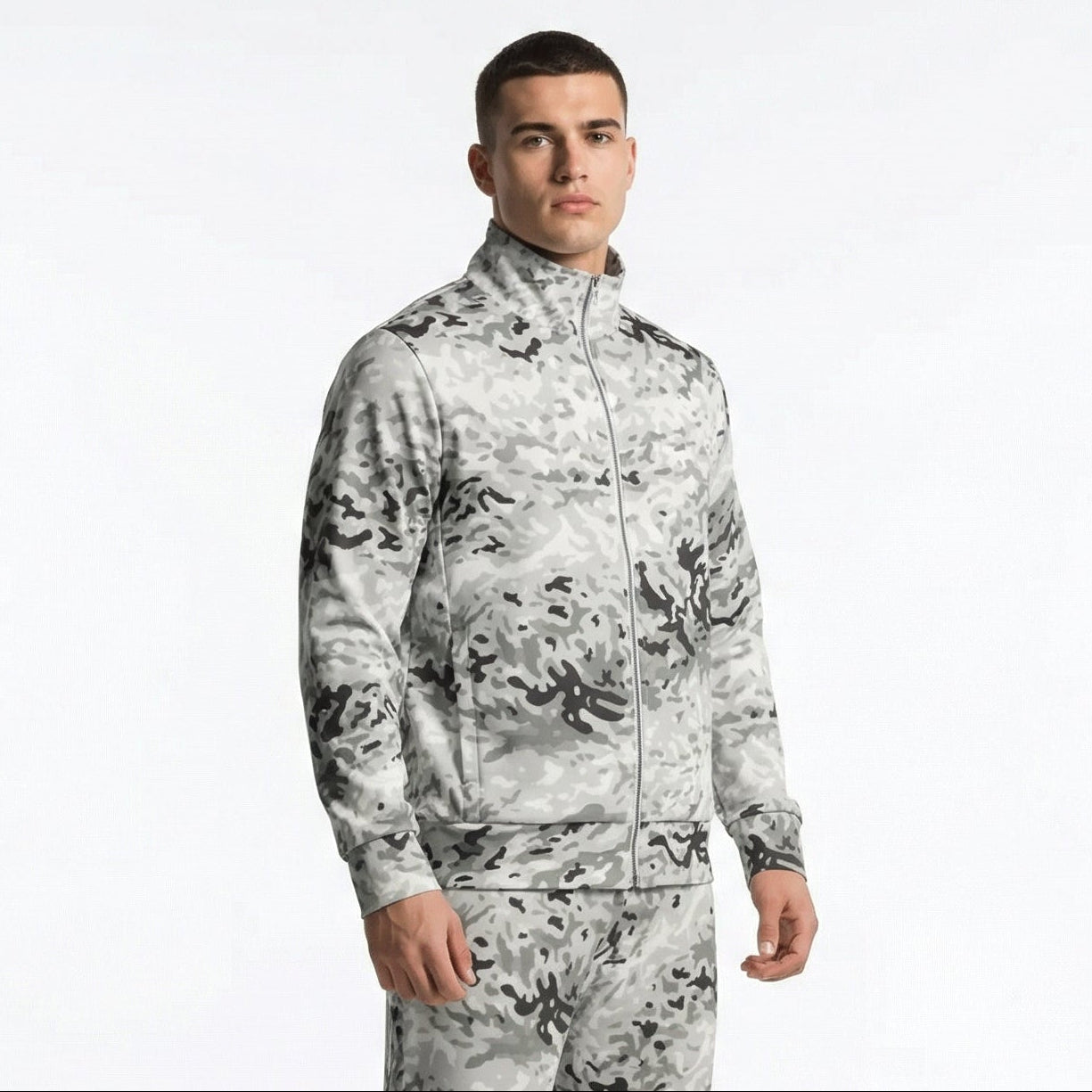 Person wearing a camouflage tracksuit on a white background