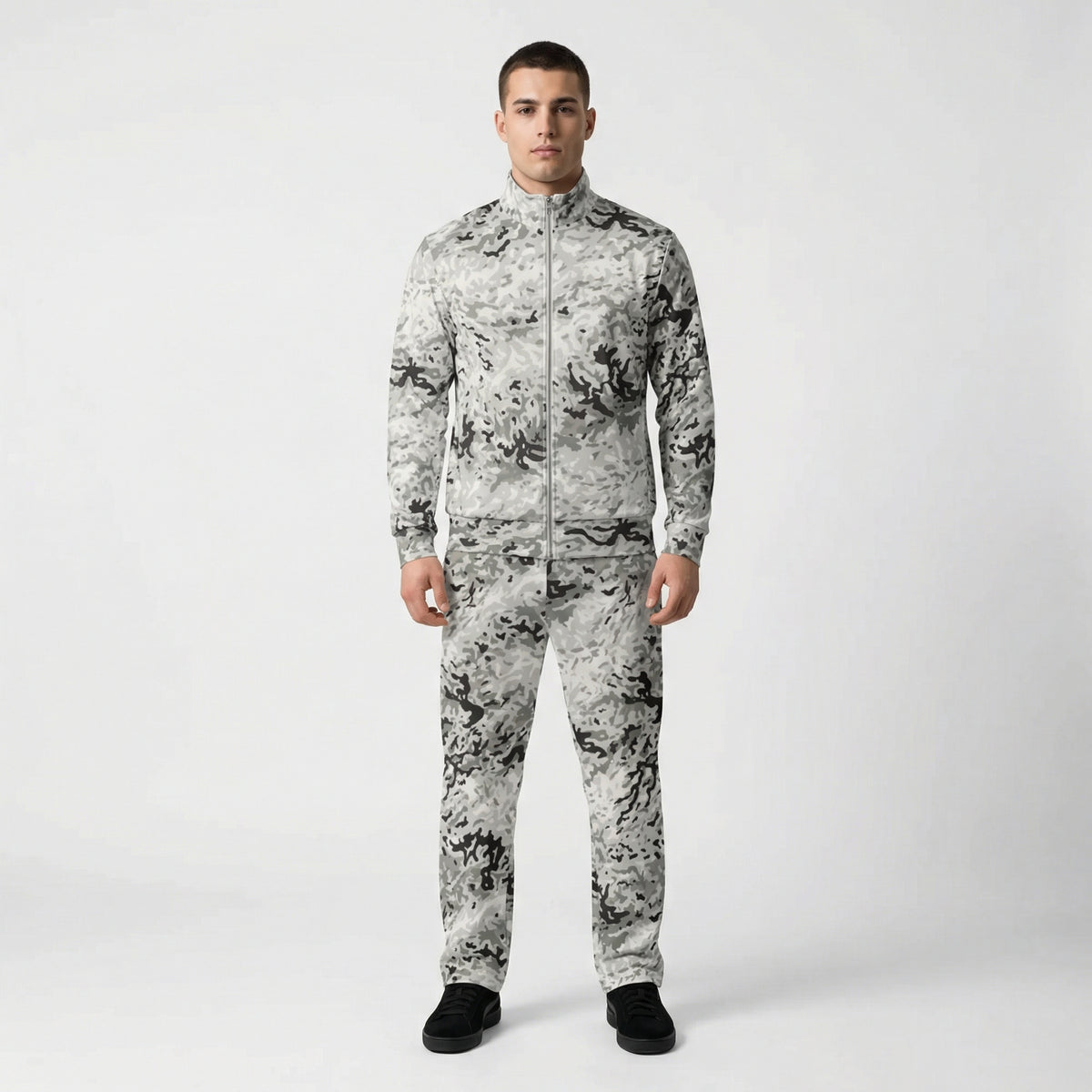 Person wearing a camouflage tracksuit on a white background