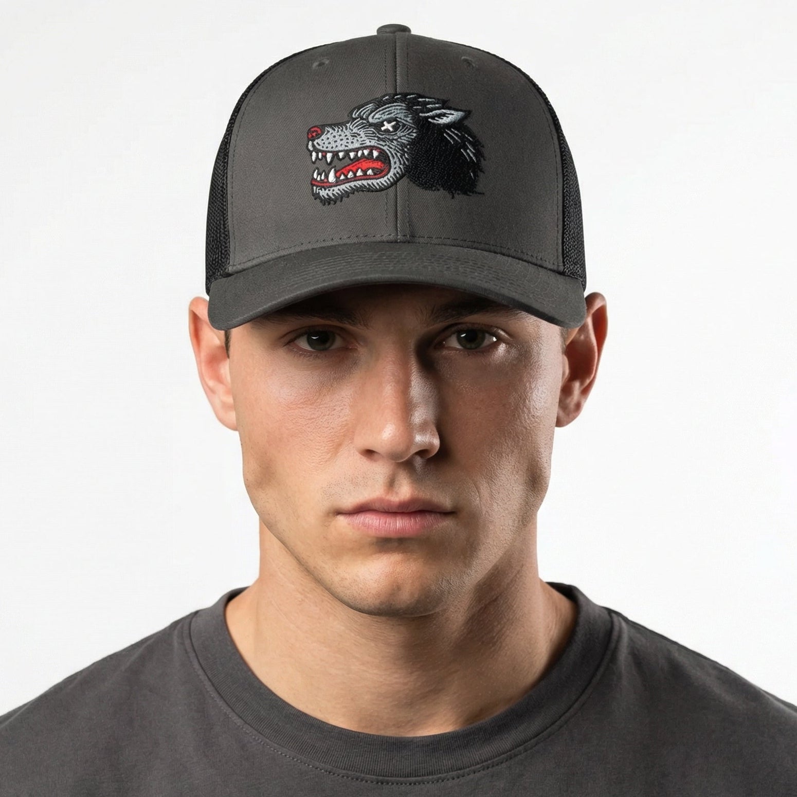 Man wearing a dark gray cap with a logo on a white background