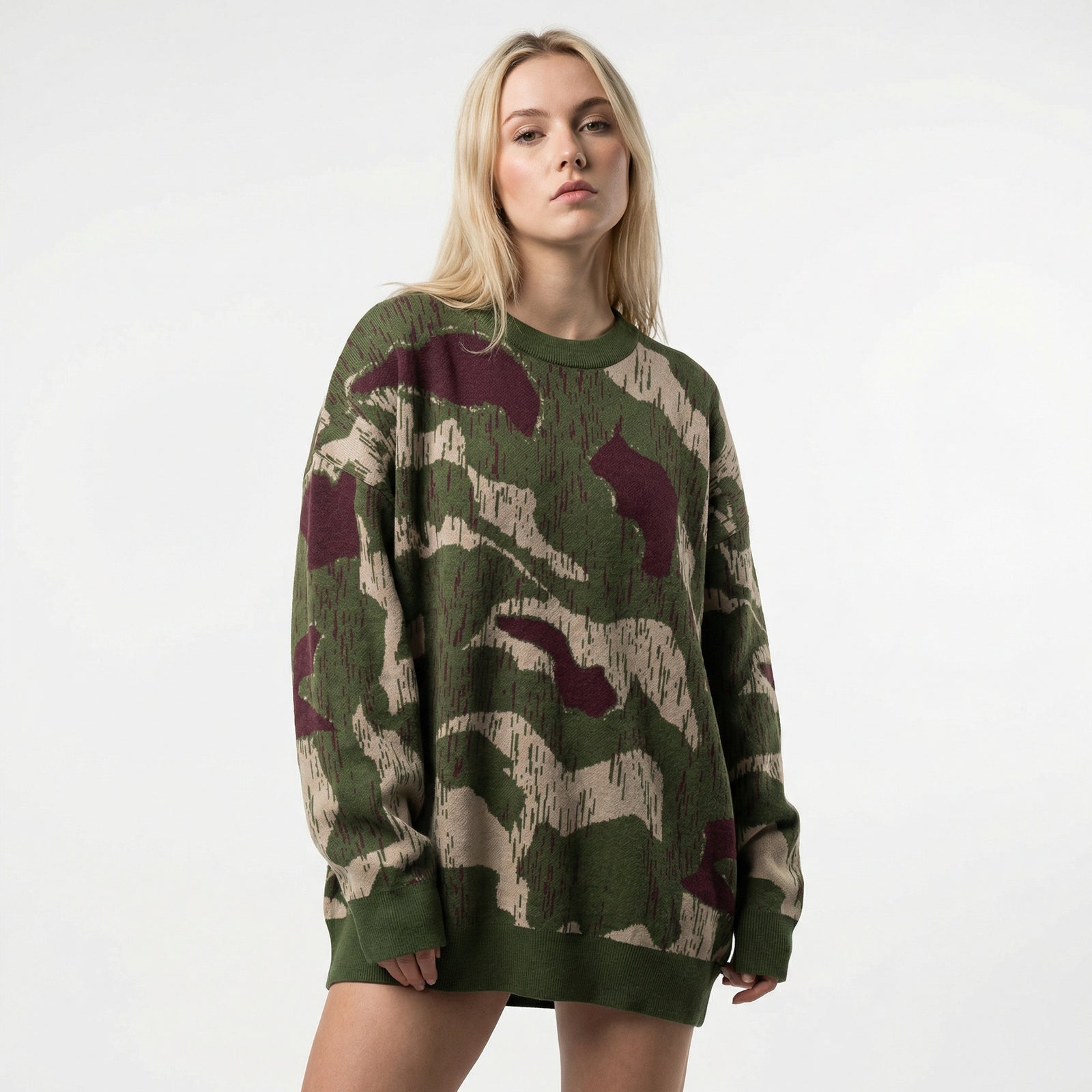 Person wearing a camouflage sweater on a white background