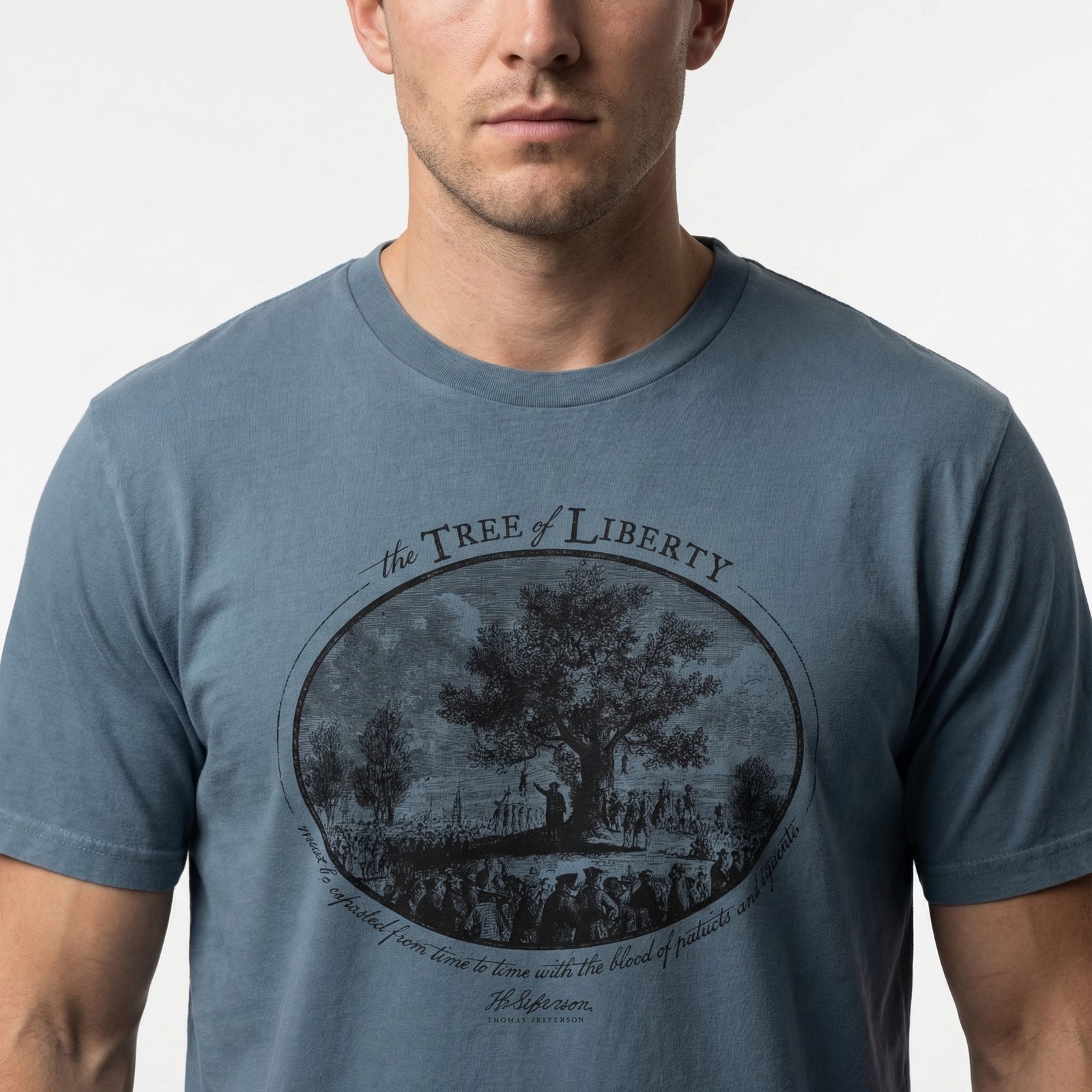 Man wearing a blue t-shirt with 'The Tree of Liberty' graphic design.