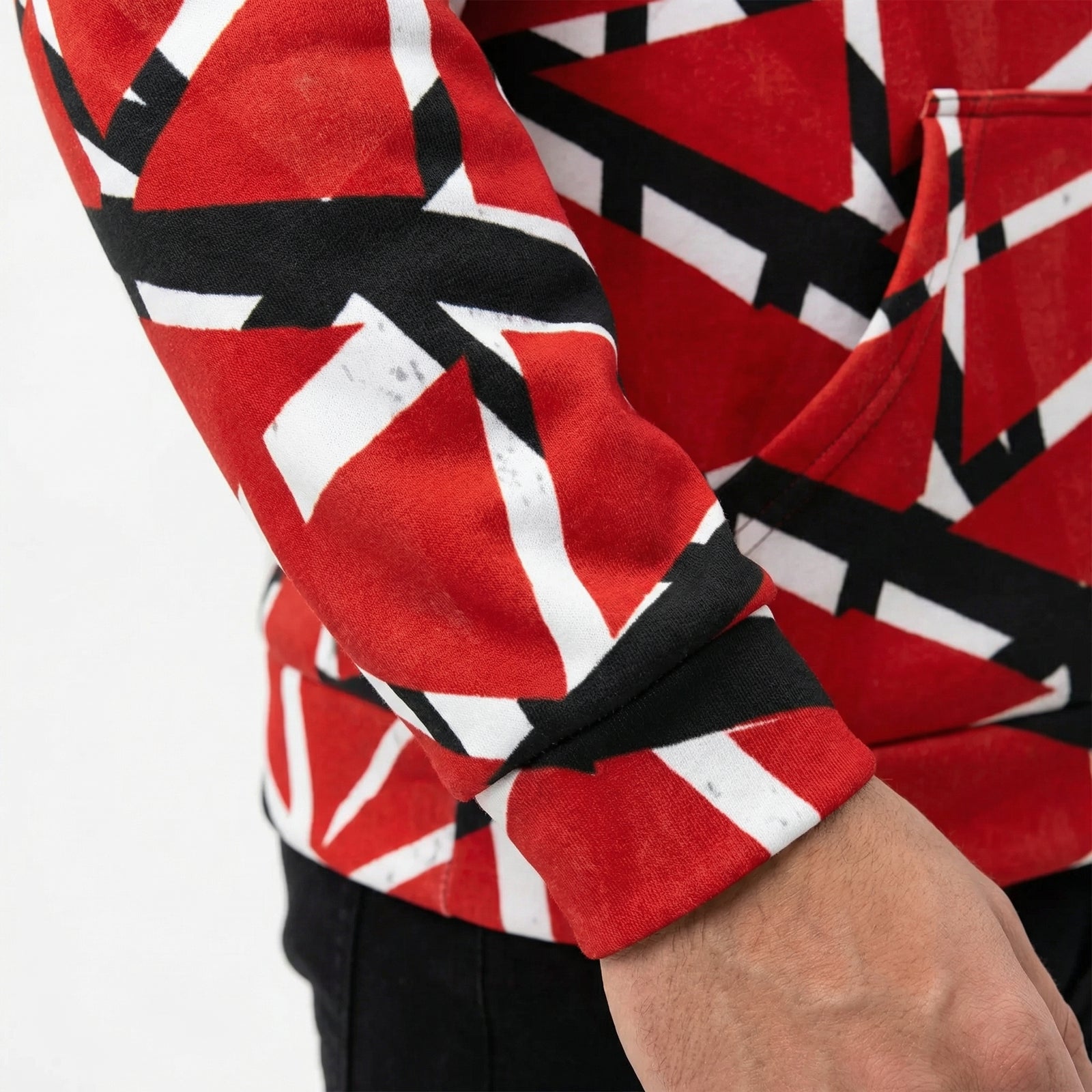 Close-up of a red, black, and white patterned shirt sleeve on a white background