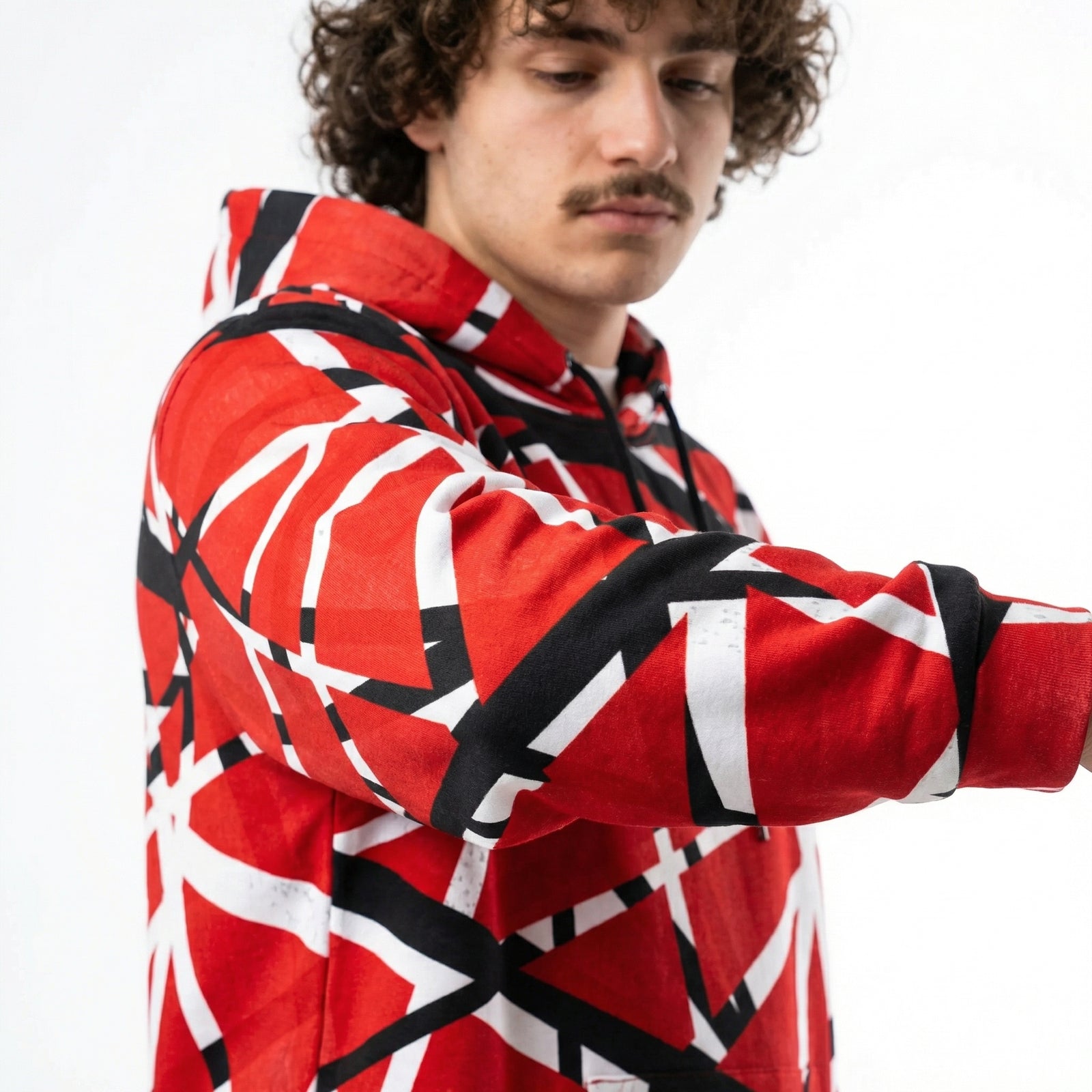 Person wearing a red, black, and white patterned jacket on a white background